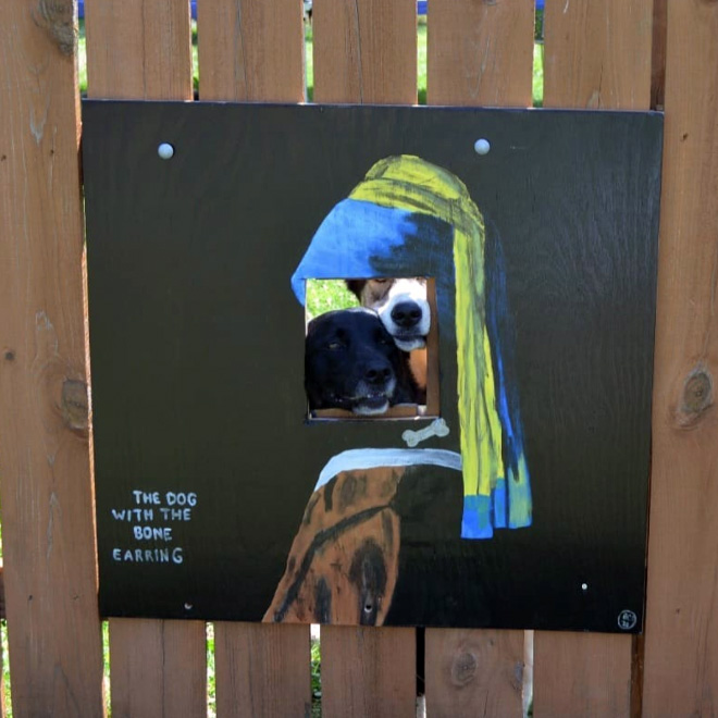 Funny fence dog window art.