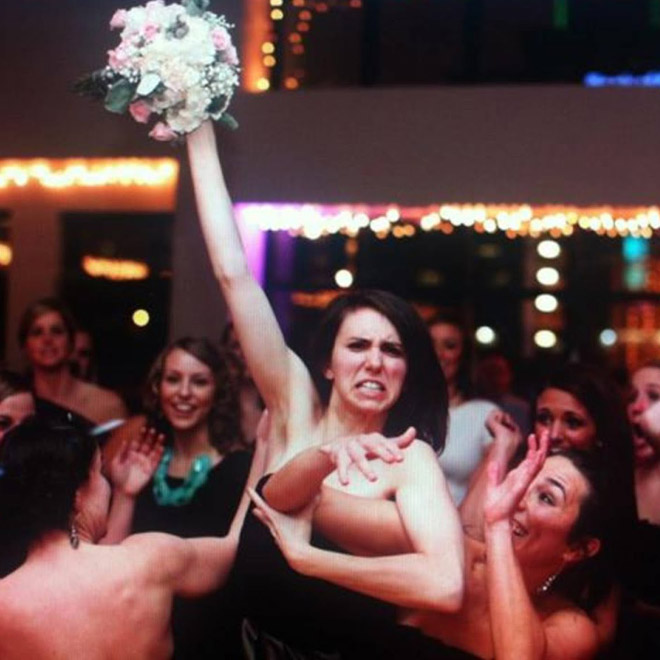 Some bridesmaids REALLY want to catch the bouquet.