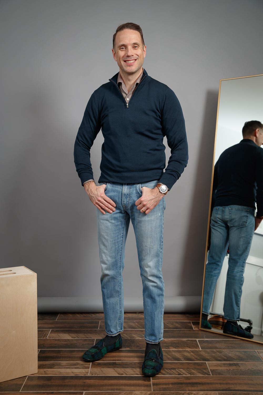 mens-casual-work-from-home-outfit-style-light-wash-jeans-brown-shirt-navy-zip-up-sweater-speedmaster-blackwatch-plaid-belgian-shoes