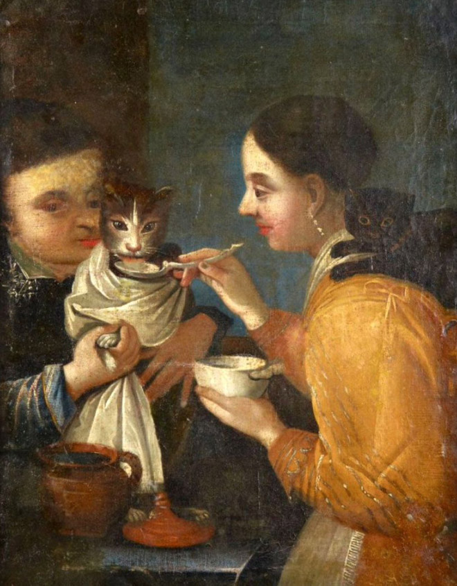 Spoon feeding cat like a little baby.