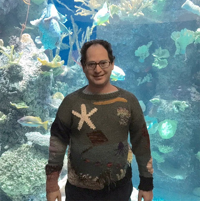 This guy wears matching sweater to the place he visits.