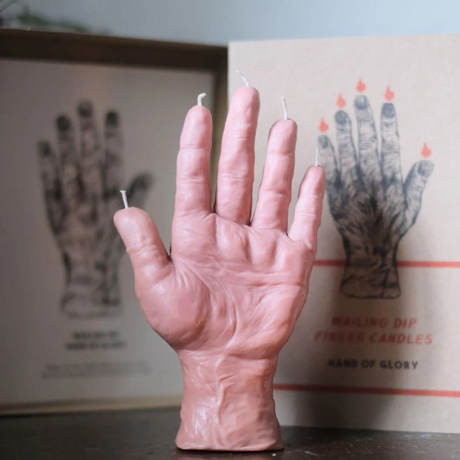 Realistic human hand candle.