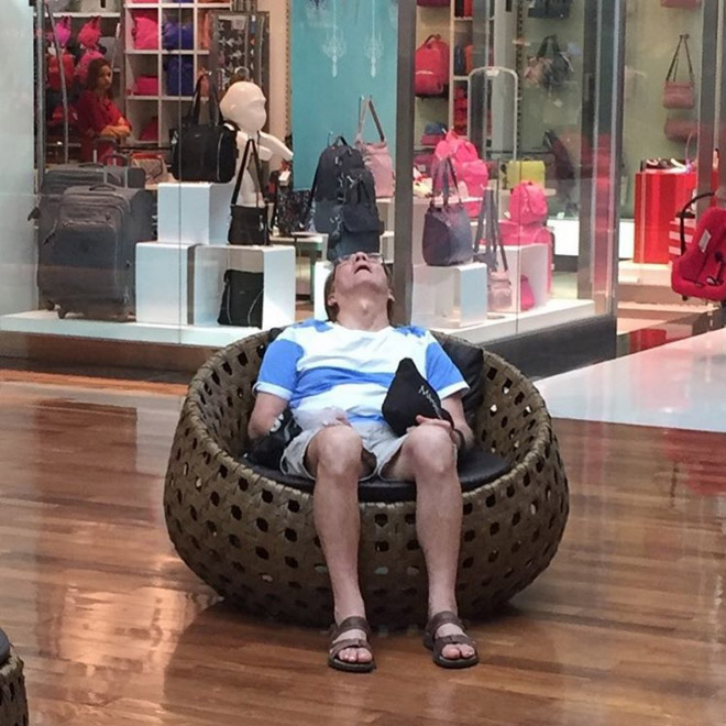 Miserable man trapped in shopping hell.
