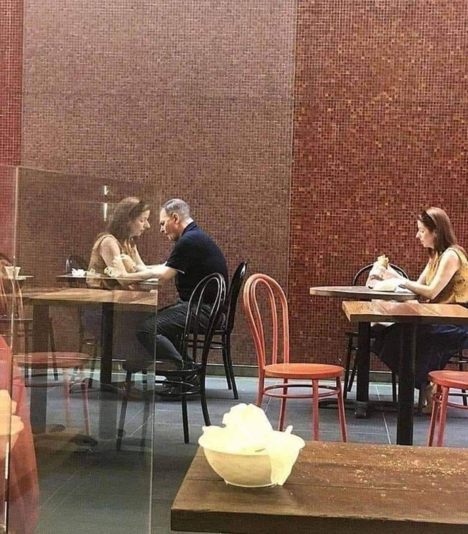 A random photo of two people alone in a cafe.