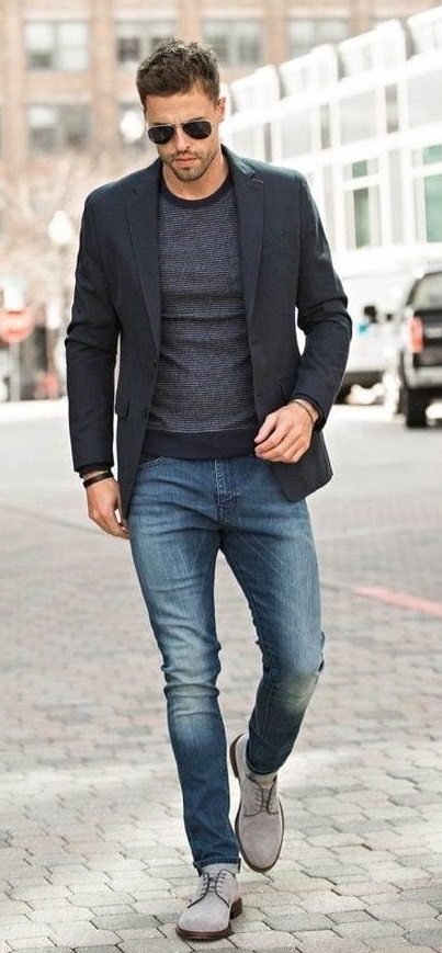 Dark grey t-shirt with a darker tone of grey colored suit Wearing a blue denim. Accessorized with shades and light grey shoes