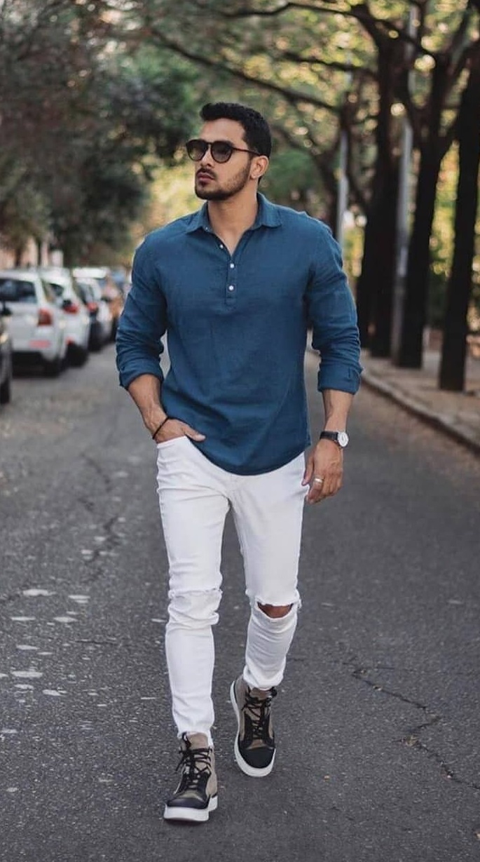 Full-sleeved t-shirt with ripped white jeans, accessorized with a watch