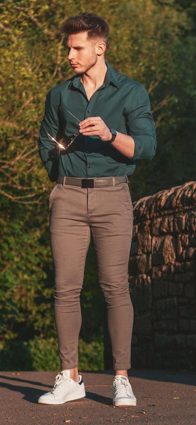 Green shirt with brown trousers and a belt, accessorized with shades_