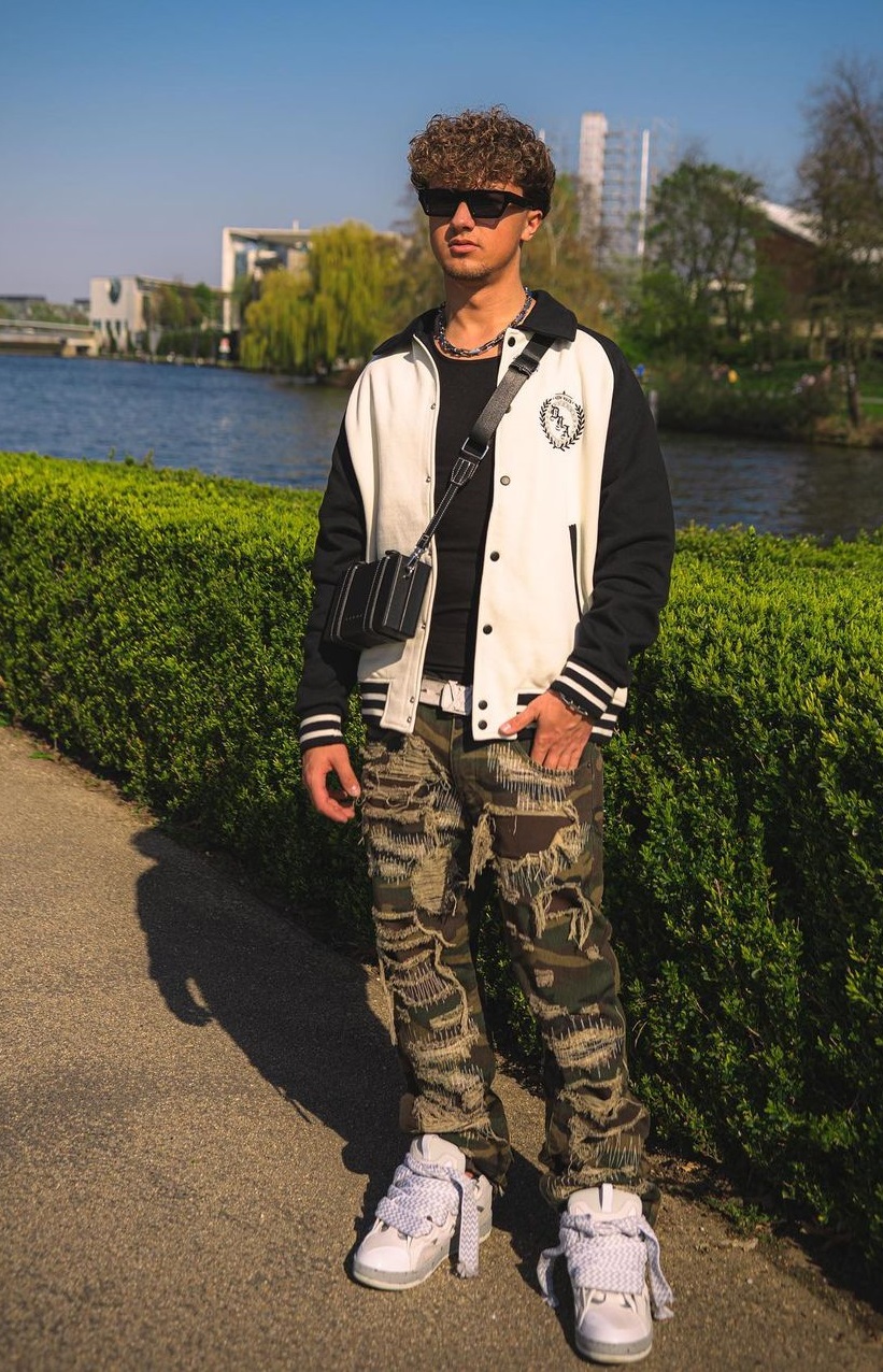 military printed shredded joggers with black tshirt and jacket paired with shoes