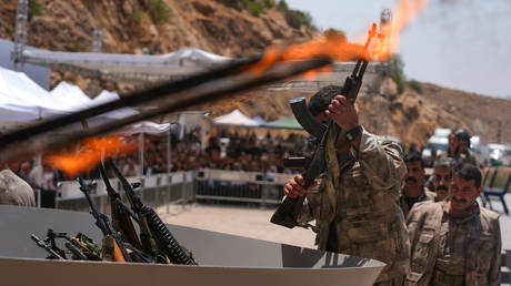 This militant group fought for 40 years. Now they’re surrendering on camera.