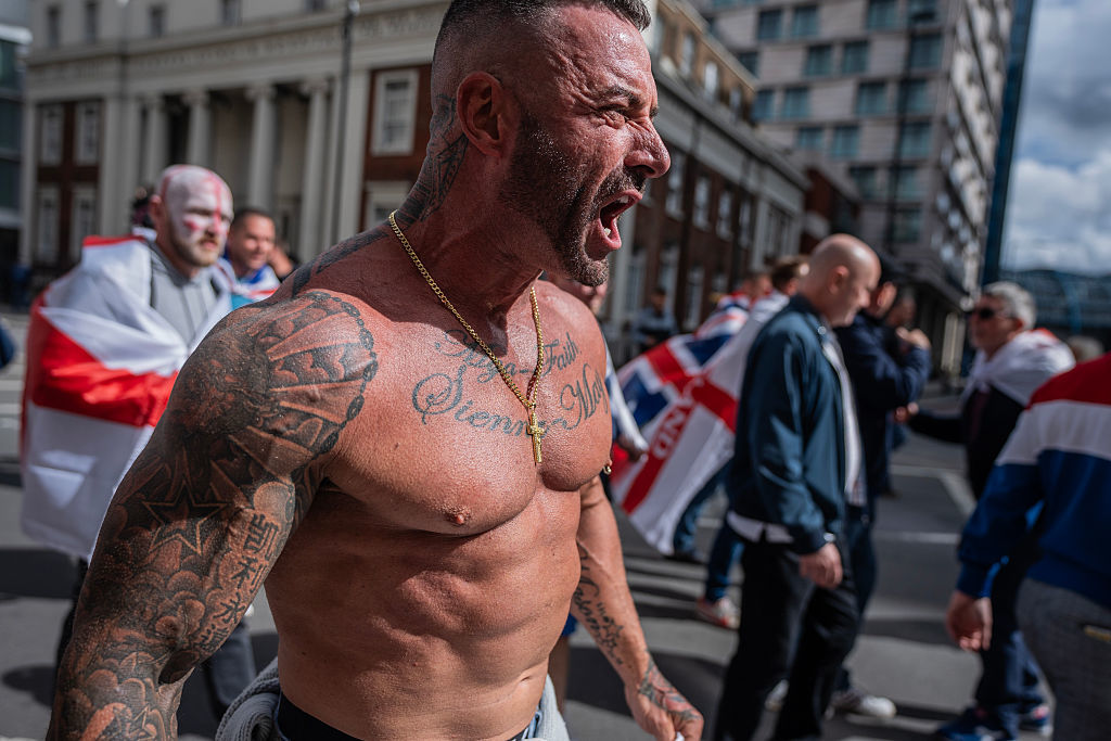 A supporter of Tommy Robinson marches towards Westminster Bridge during the 'Unite the Kingdom' rally in London, England, September 13, 2025