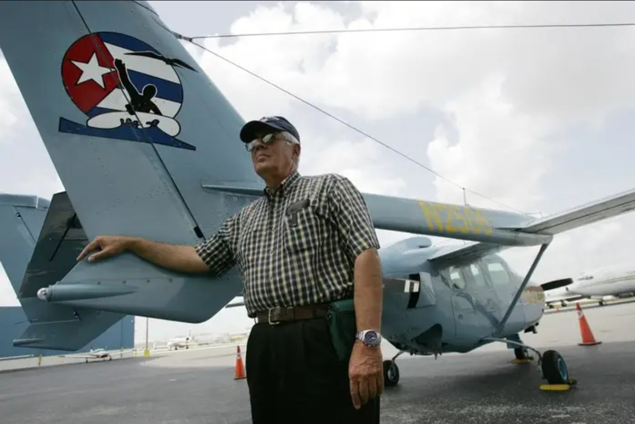 Jose Basulto poses beside a 'Brothers to the Rescue' plane, 2006