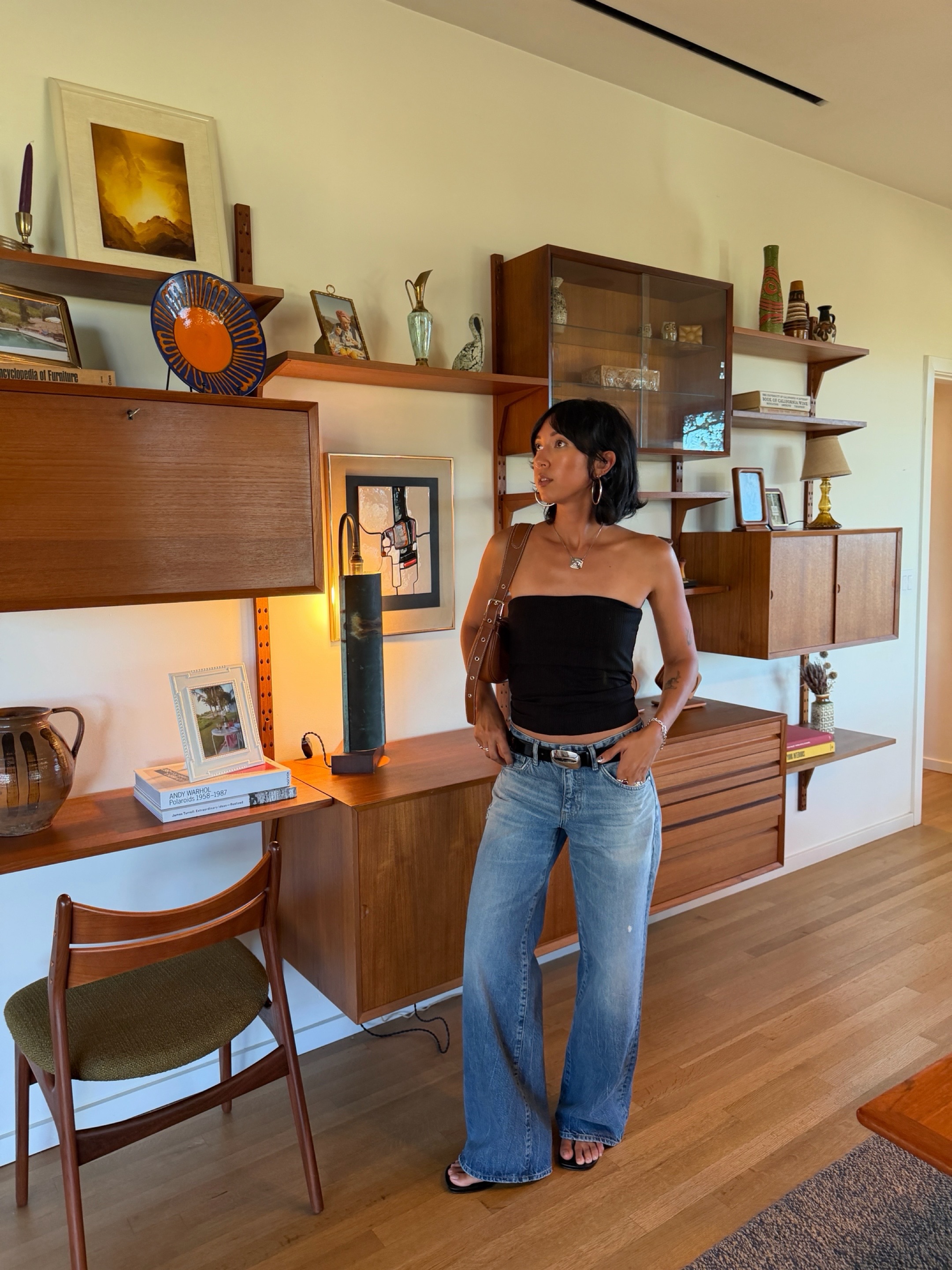 An image of a woman wearing jeans black sandals outfit 2026