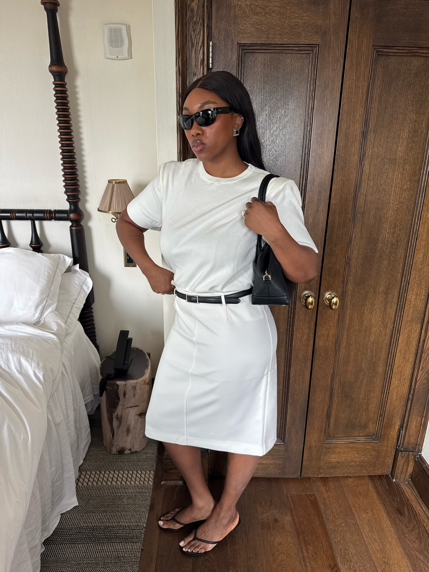 An image of @nnennaechem  wearing a white pencil skirt, one of the best '90s summer trends coming back in 2026.