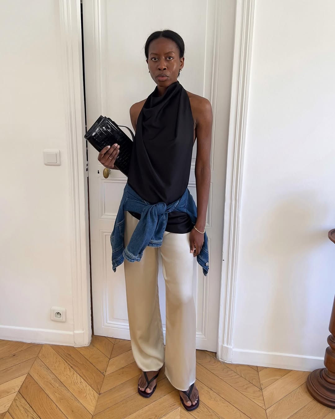 Influencer Sylvie Mus wearing beige silk trousers.