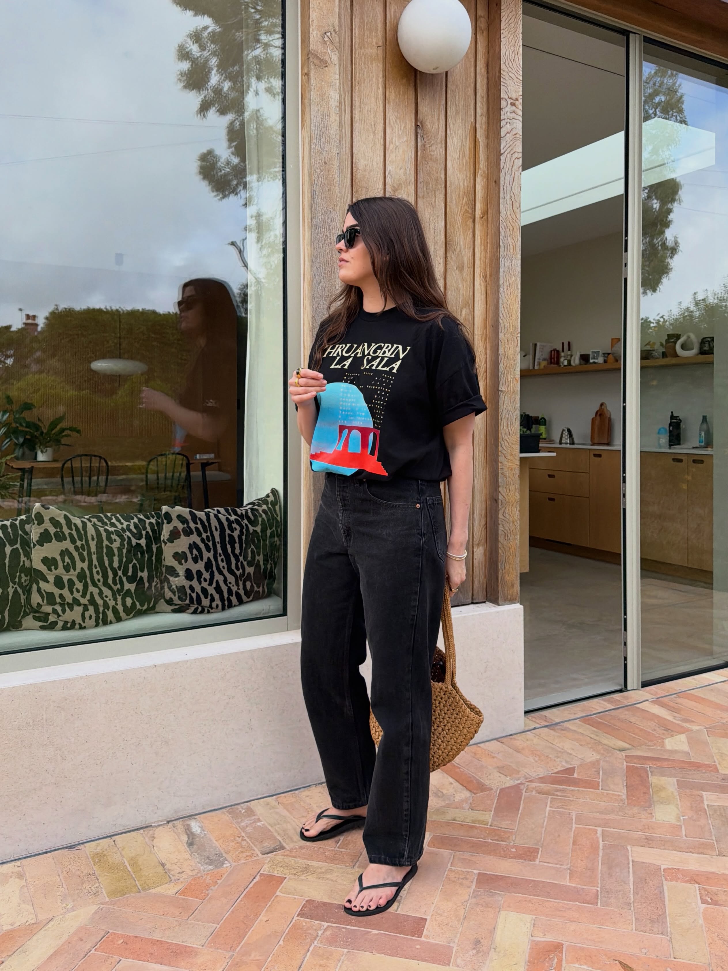 An image of a woman wearing jeans black sandals outfit 2026