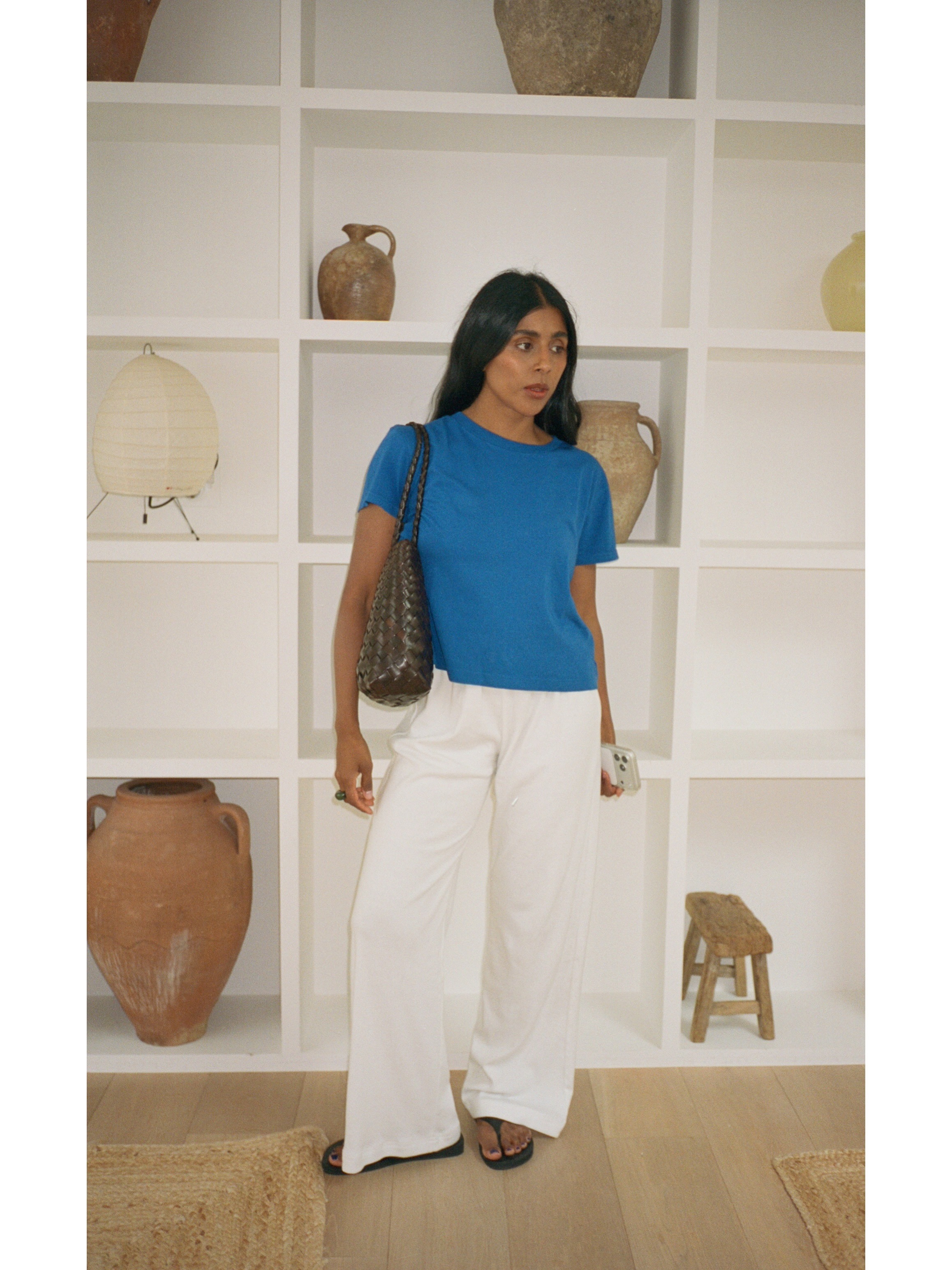 Woman in a blue t-shirt and white pants