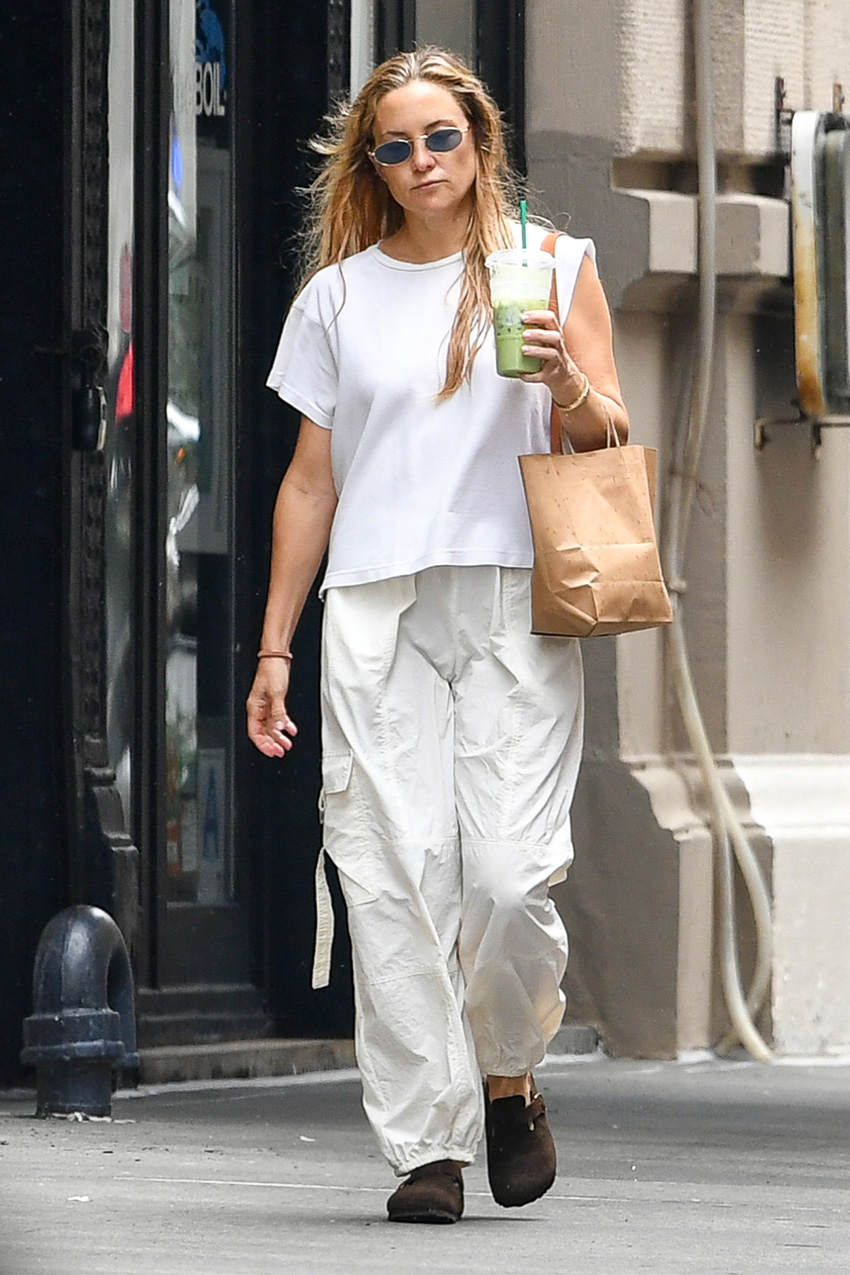 Kate Hudson wearing a white T-shirt, balloon cargo pants, and Birkenstock Boston clogs
