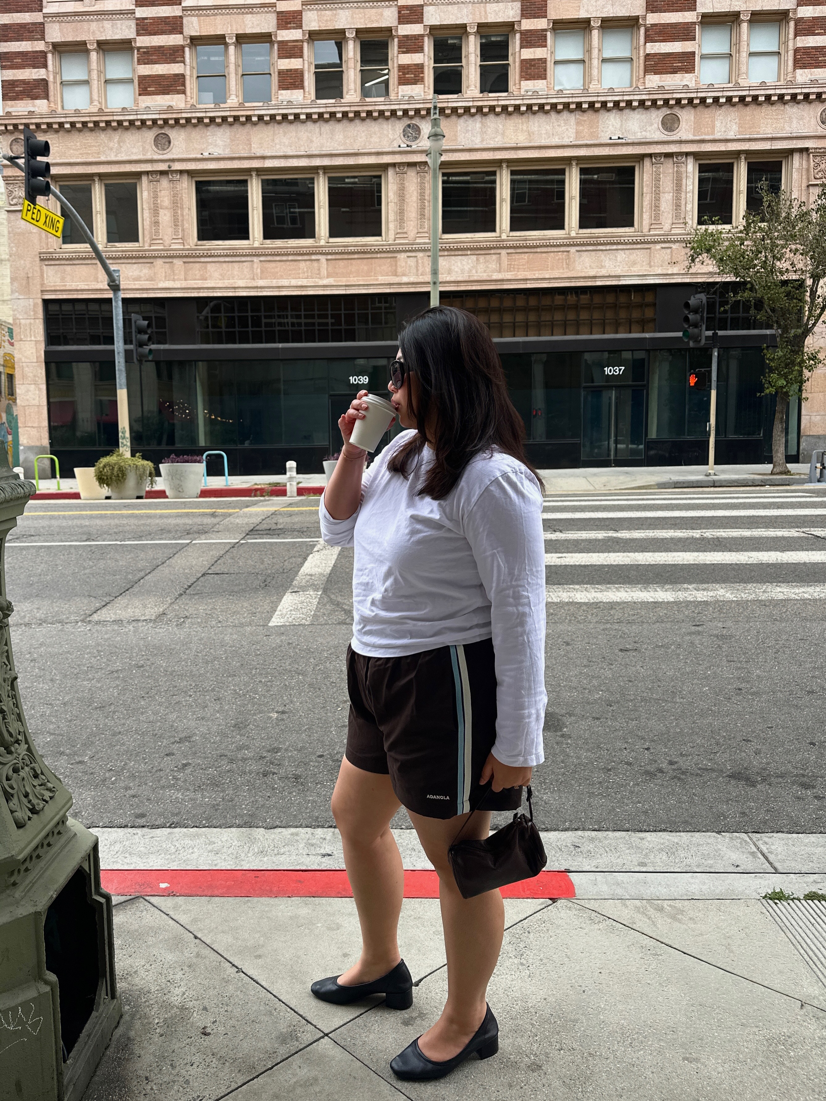 An image of @marina_torres  wearing a track shorts, one of the best '90s summer trends coming back in 2026.