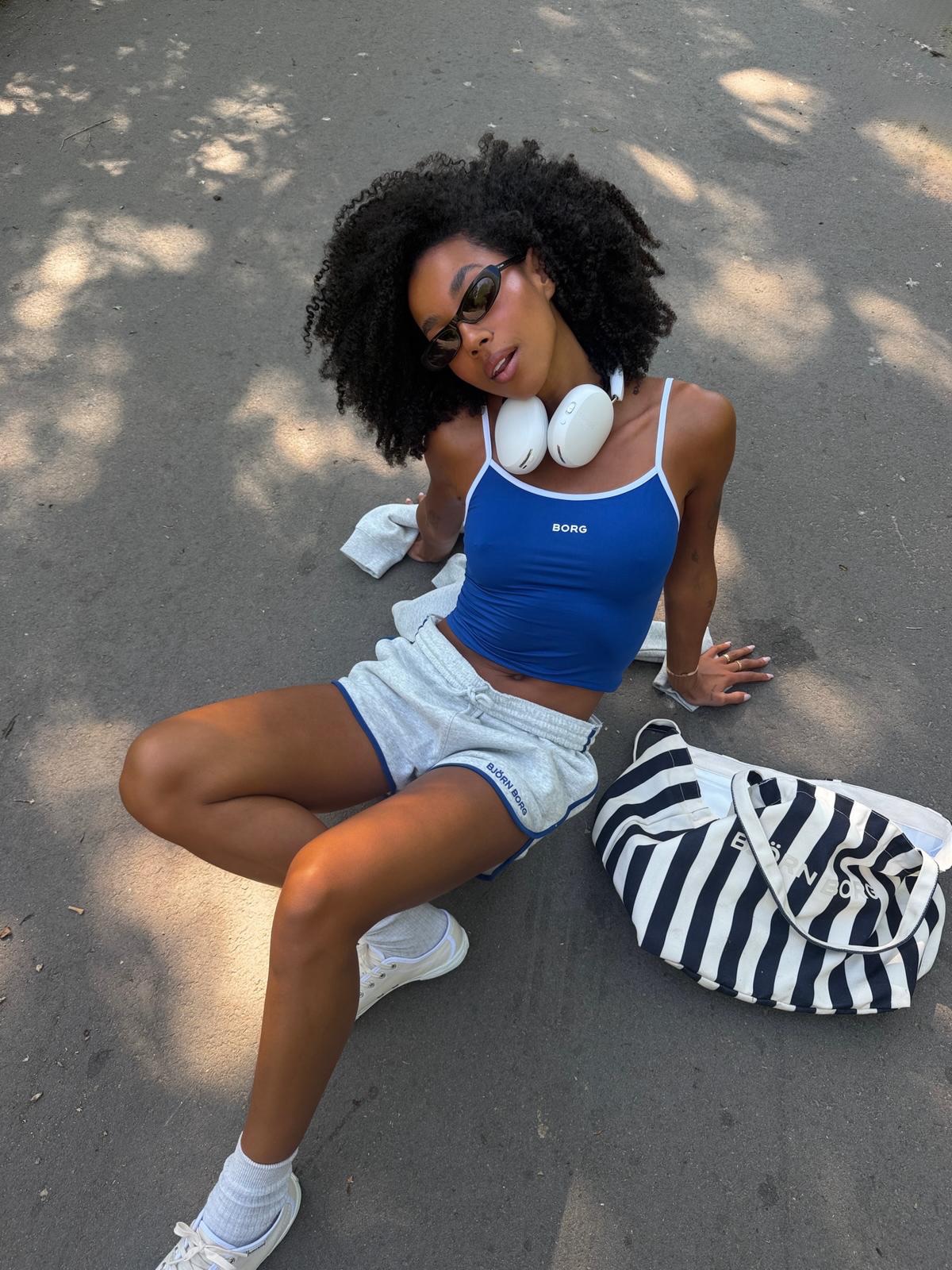 An image of a woman wearing best shoes with sporty shorts