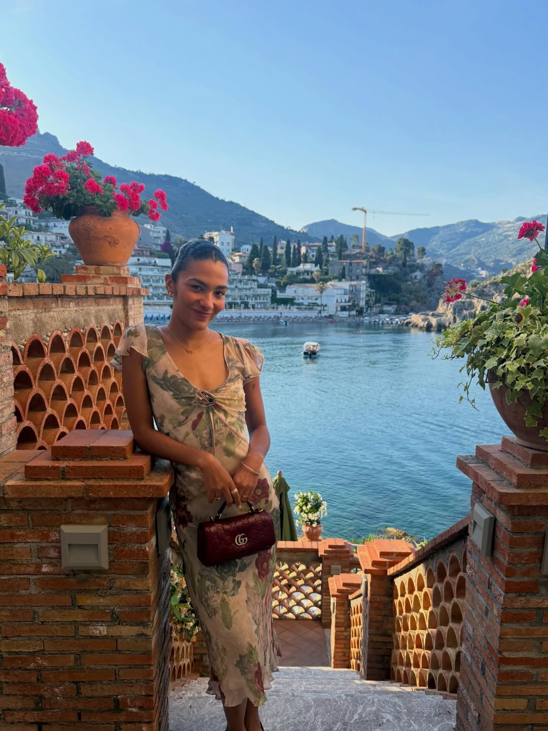 An image of Olivia Dean wearing the Realisation Par Meg dress, one of the biggest rosette dress trend.