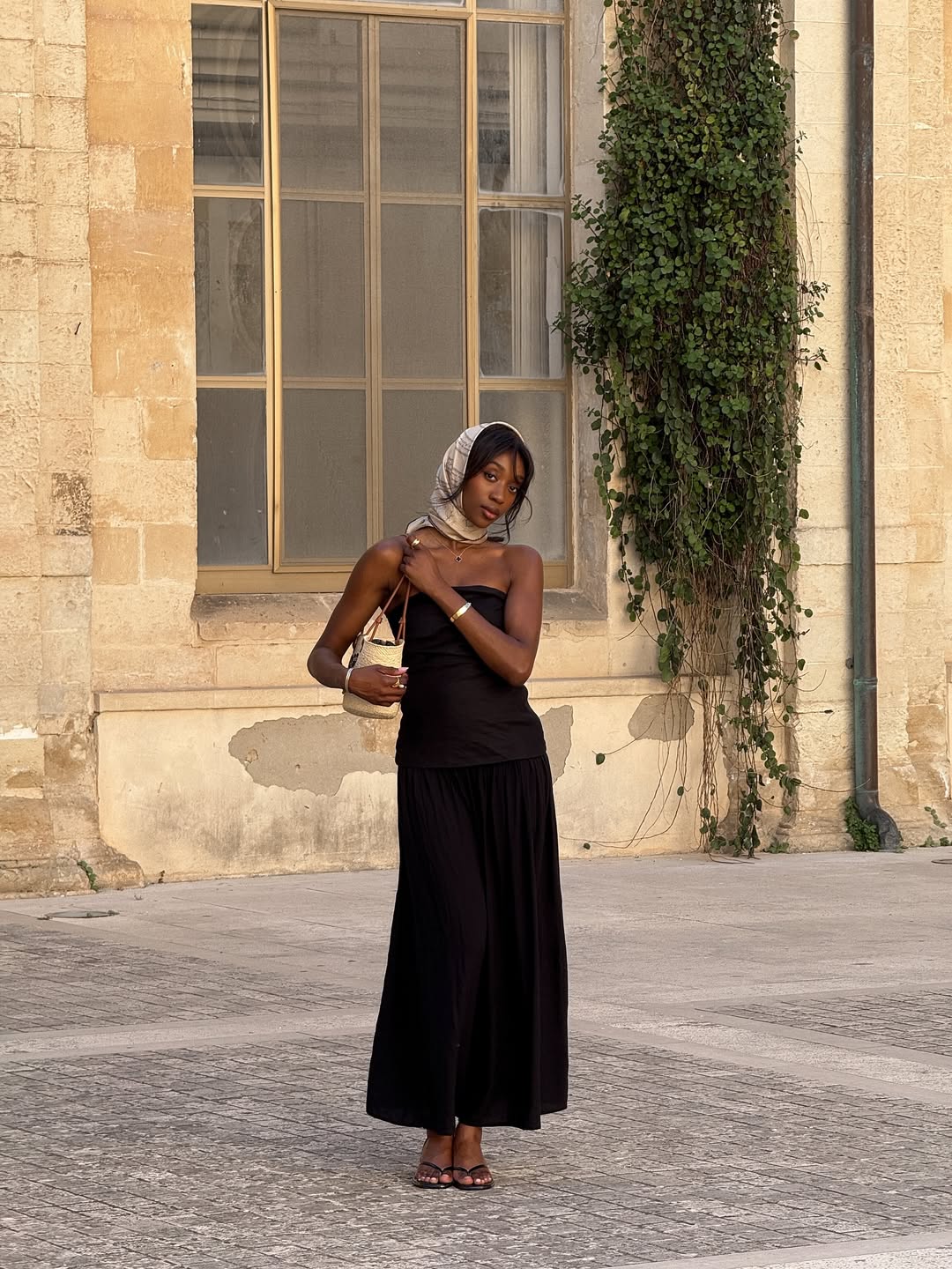 Emmanuelle in a black strapless sundress and silk scarf