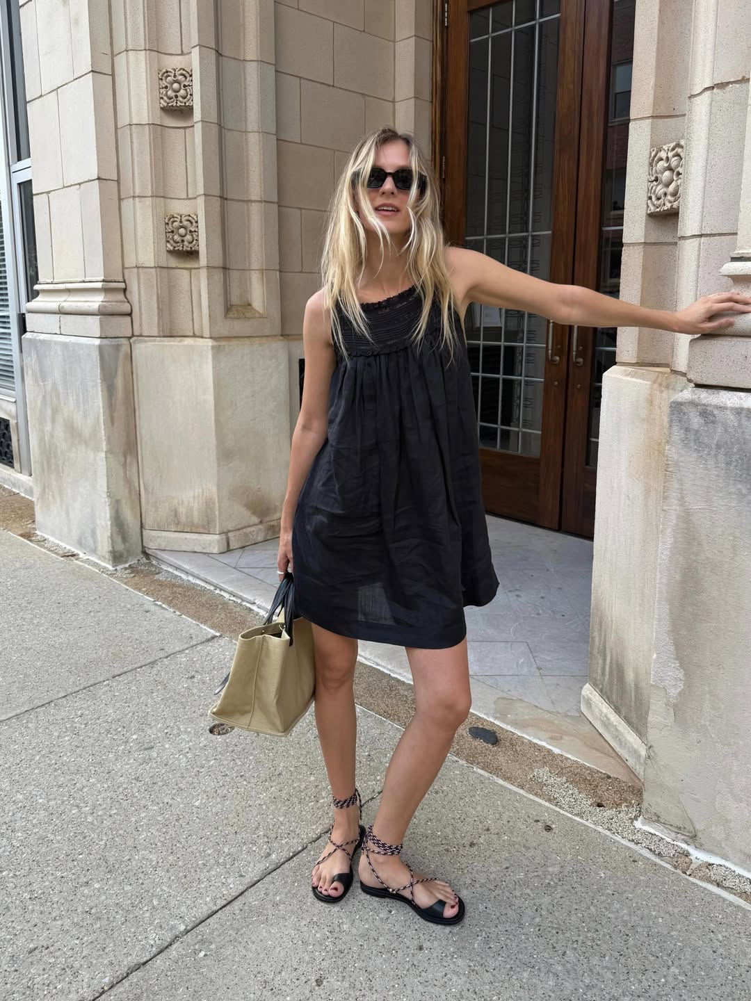 @hannahallen00 wearing black mini dress with sunglasses and sandals@hannah