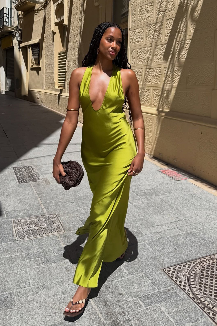 a woman wearing a green satin dress