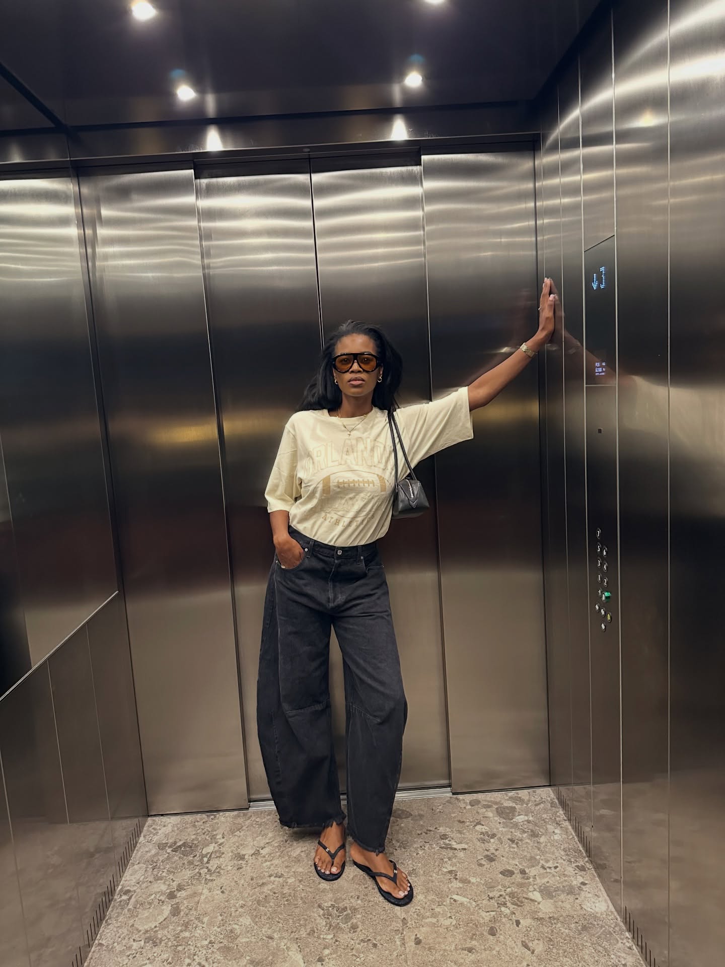 An image of a woman wearing jeans black sandals outfit 2026