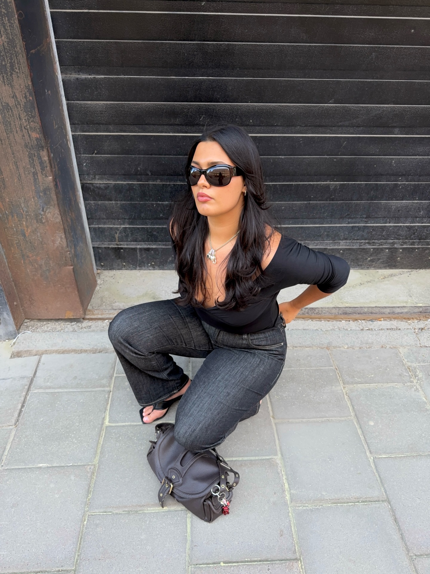 An image of a woman wearing jeans black sandals outfit 2026