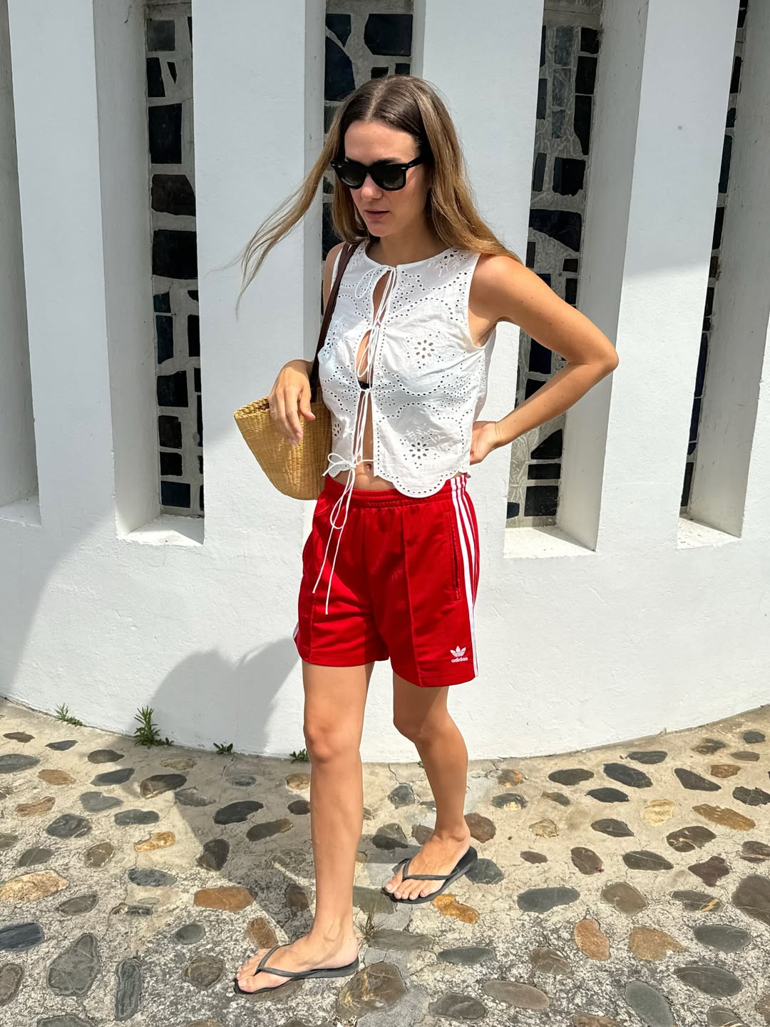 Anne-Laure in red shorts and white embroidered top