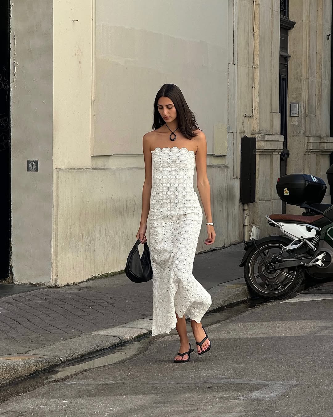 White sundress with pendant necklace and heeled flip-flops