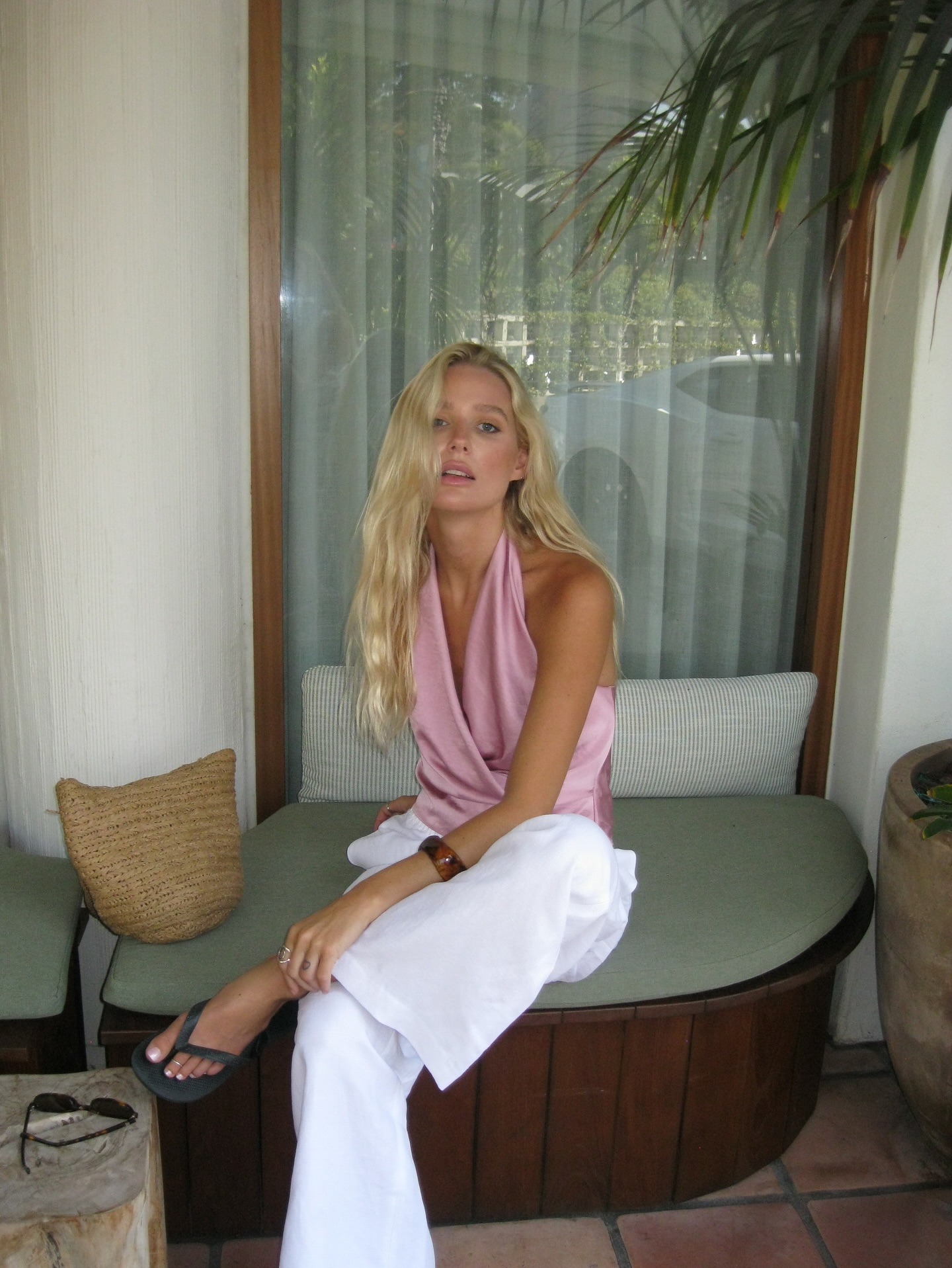 Woman in a pink top and white pants