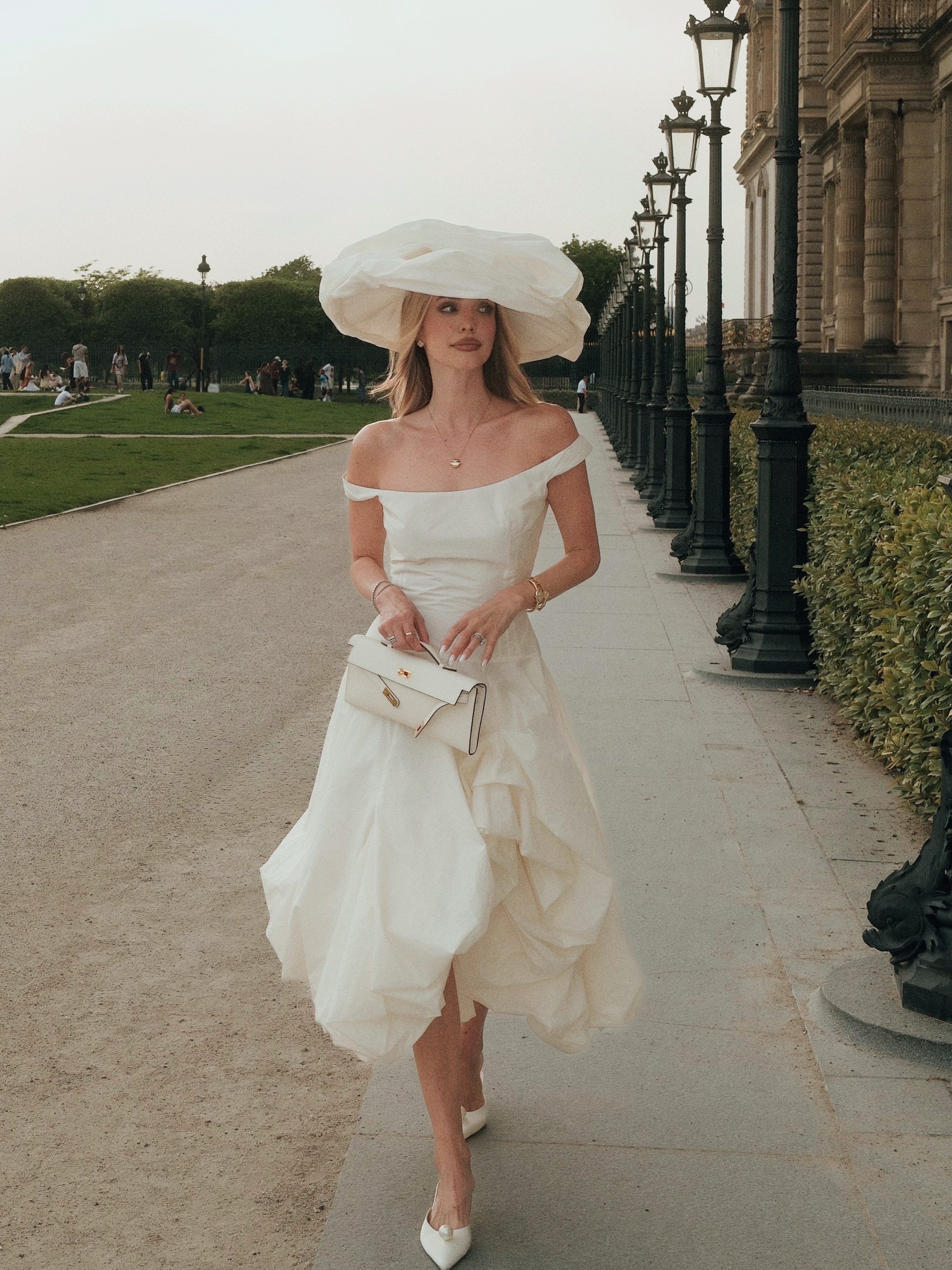 Woman wearing white elopement outfit.