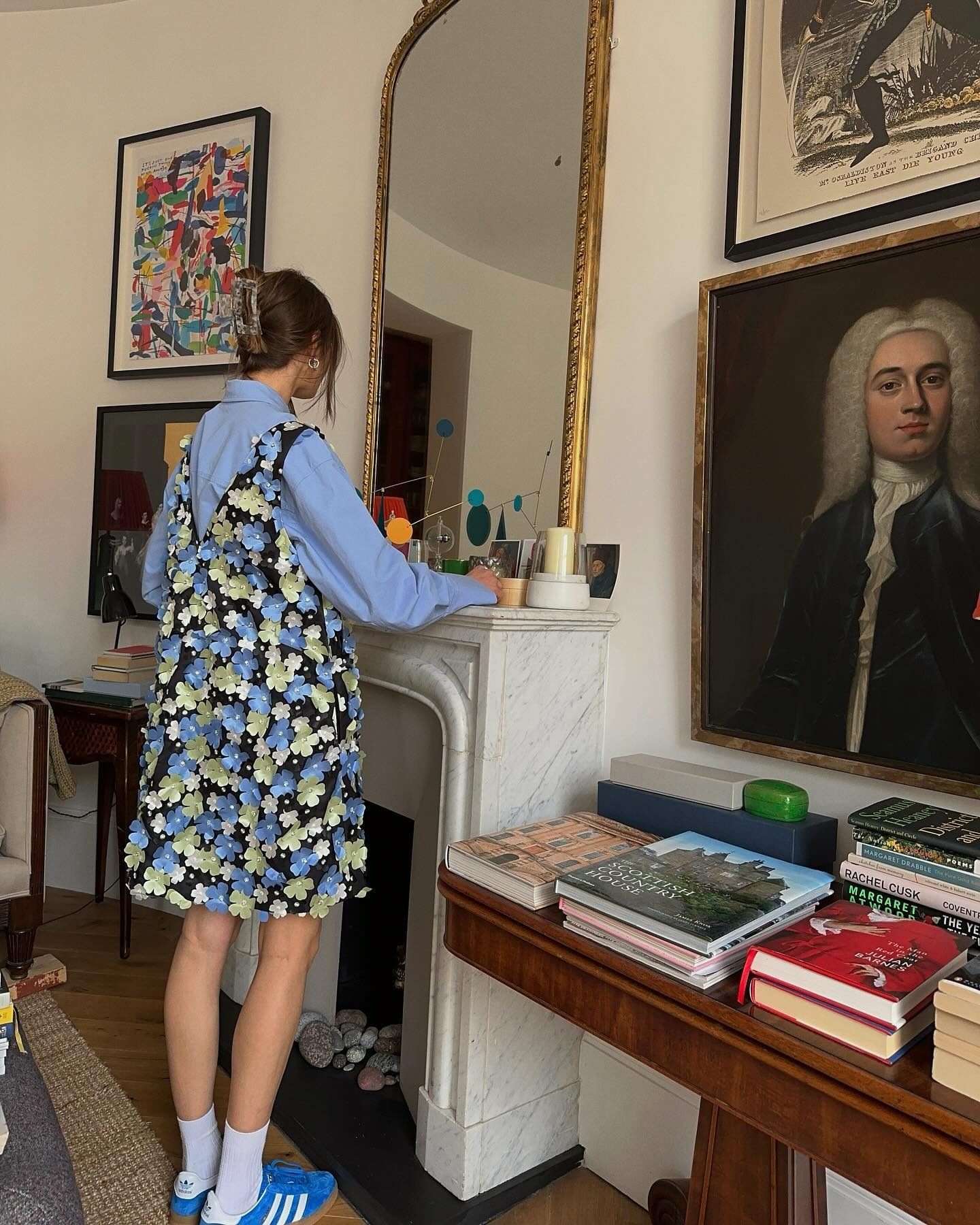 Influencer @poppyalmond wears cobalt blue trainers with a floral minidress.