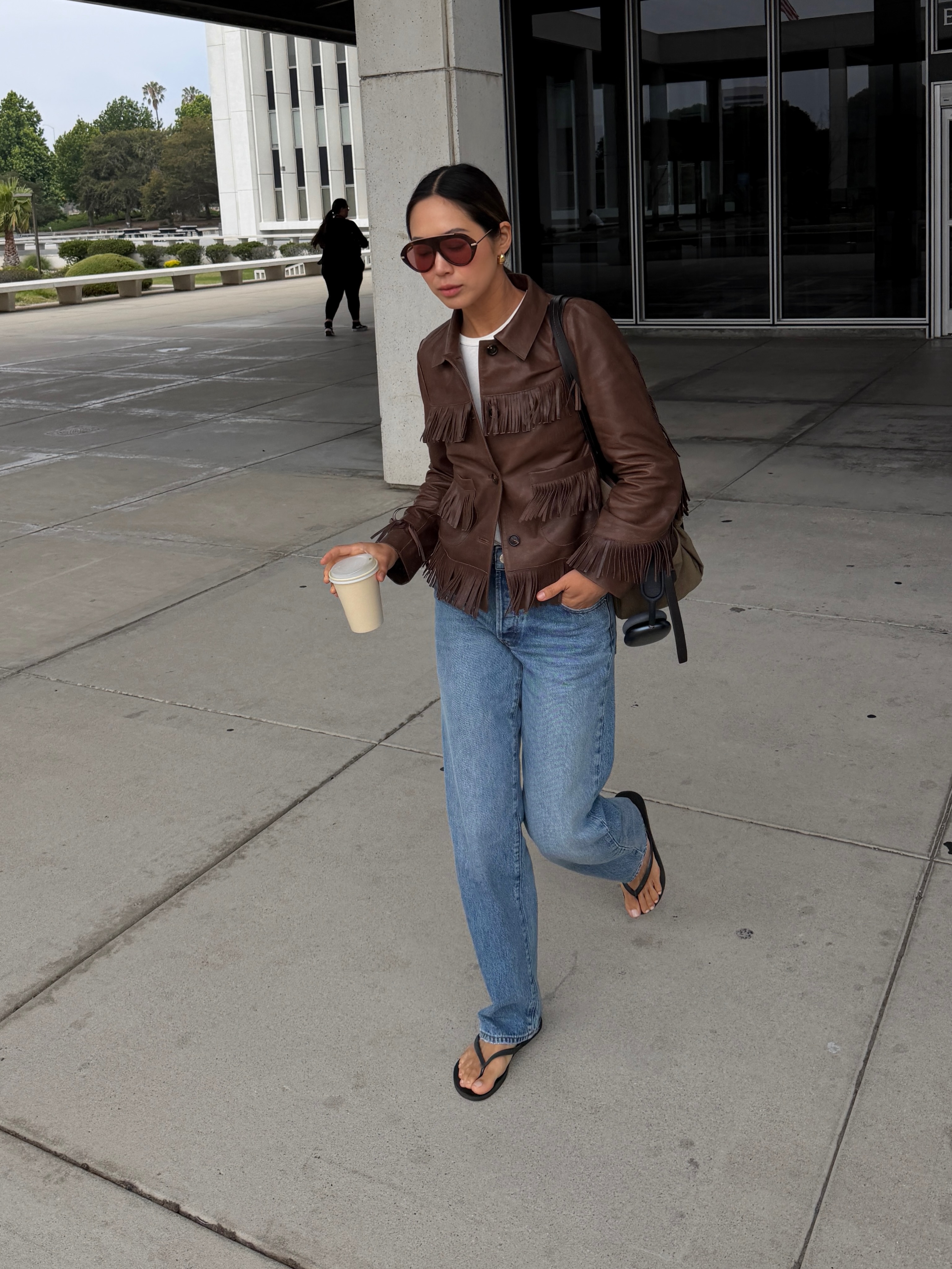 An image of a woman wearing jeans black sandals outfit 2026