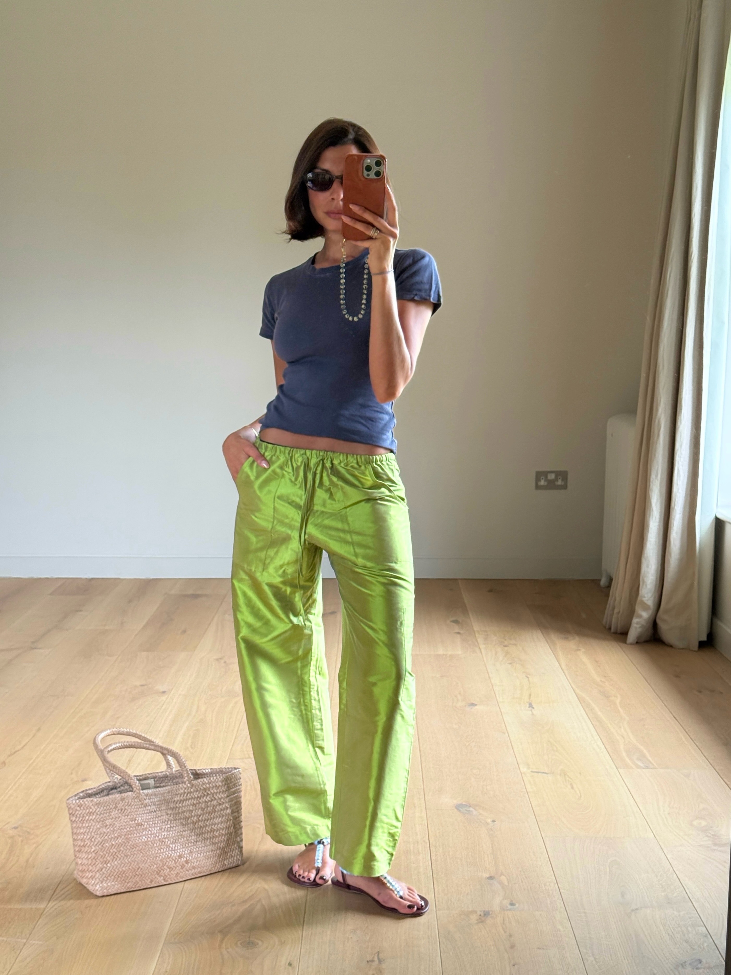 Woman in a blue top and chartreuse green pants