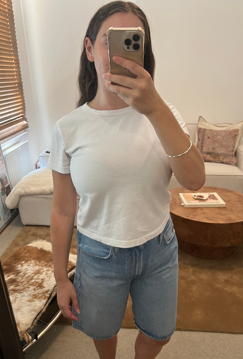 An image of Who What Wear fashion writer Ava Gilchrist wearing a pair of Citizens of Humanity denim shorts, one of the best denim shorts for women in 2026.