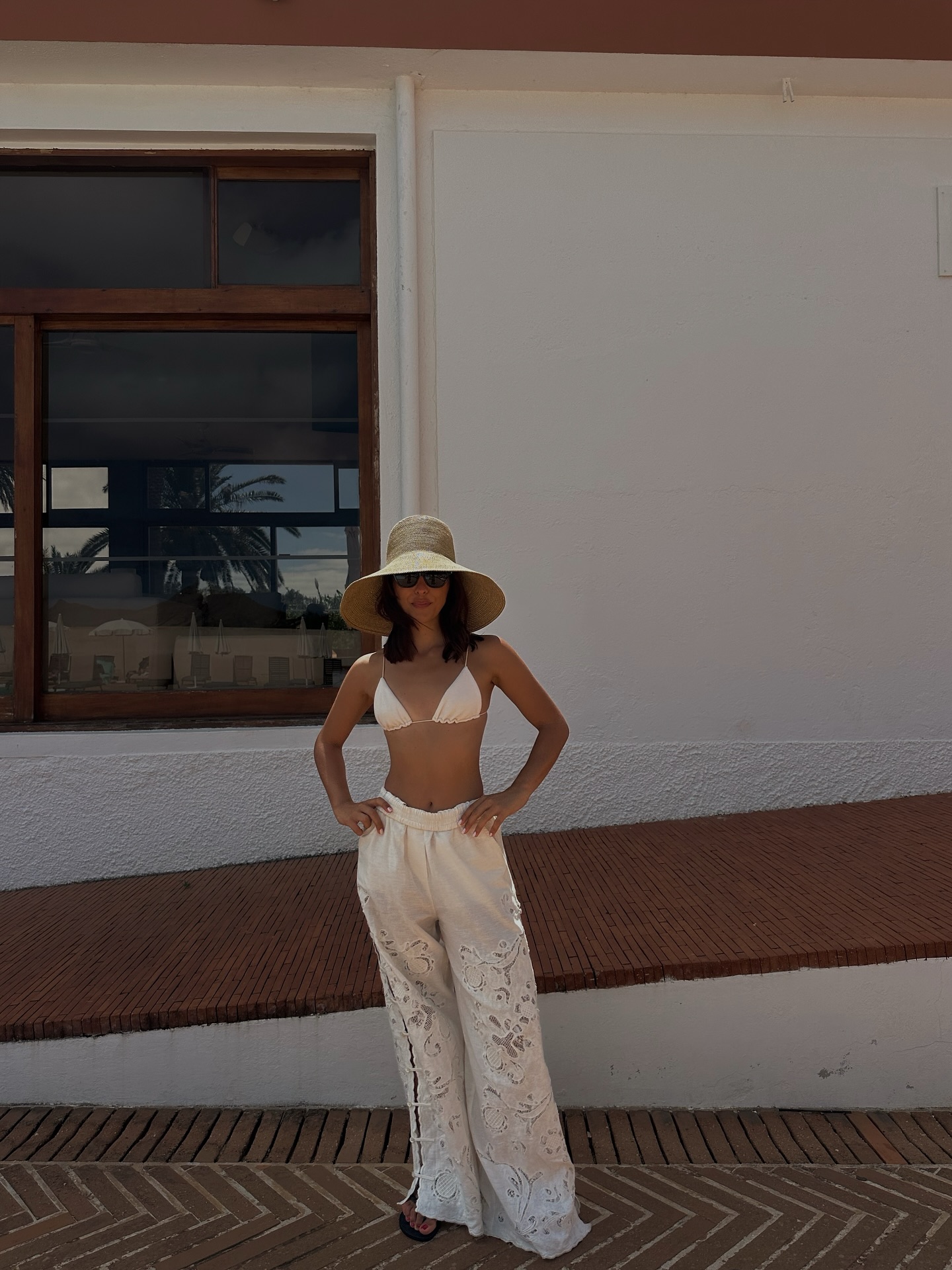 Debora Rosa in white embroidered pants.