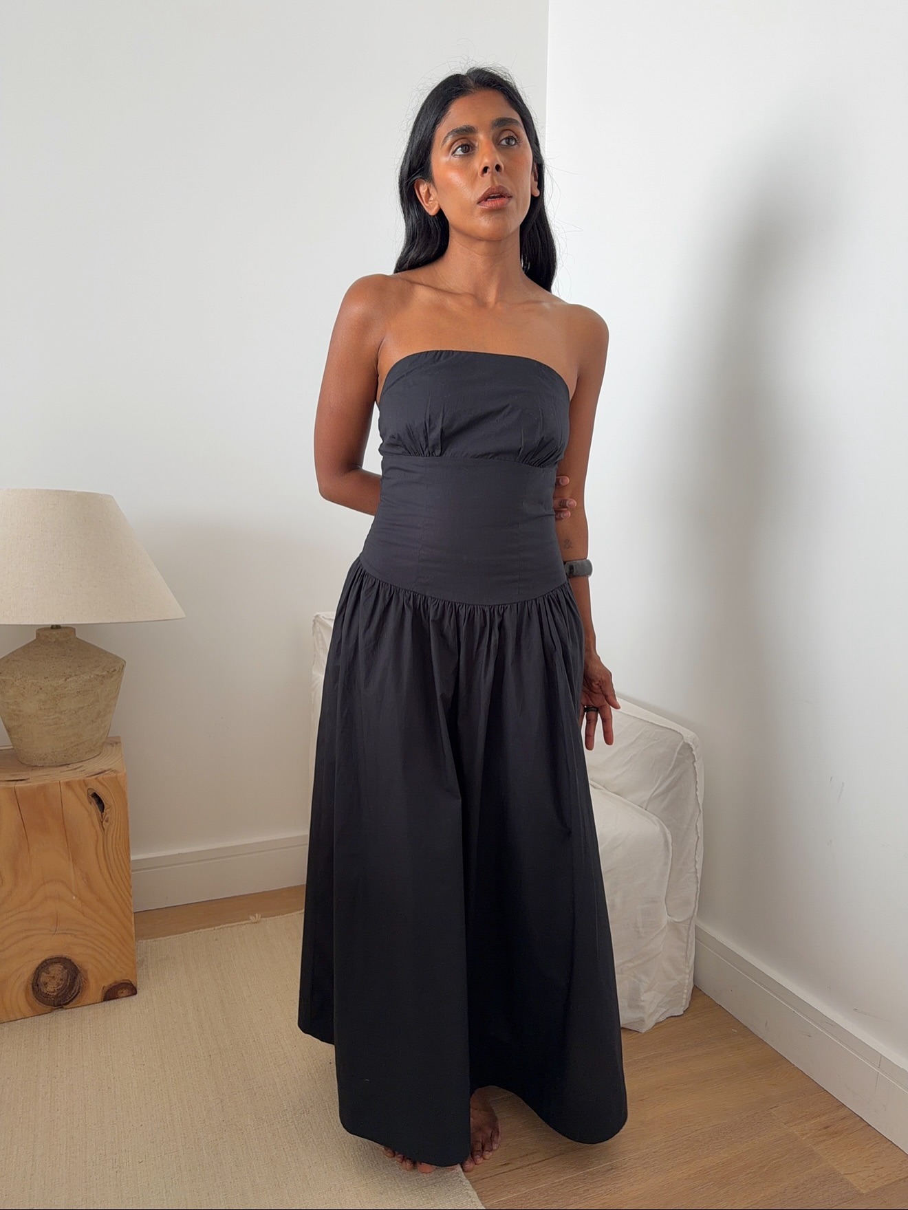 Monikh wearing a strapless black dress