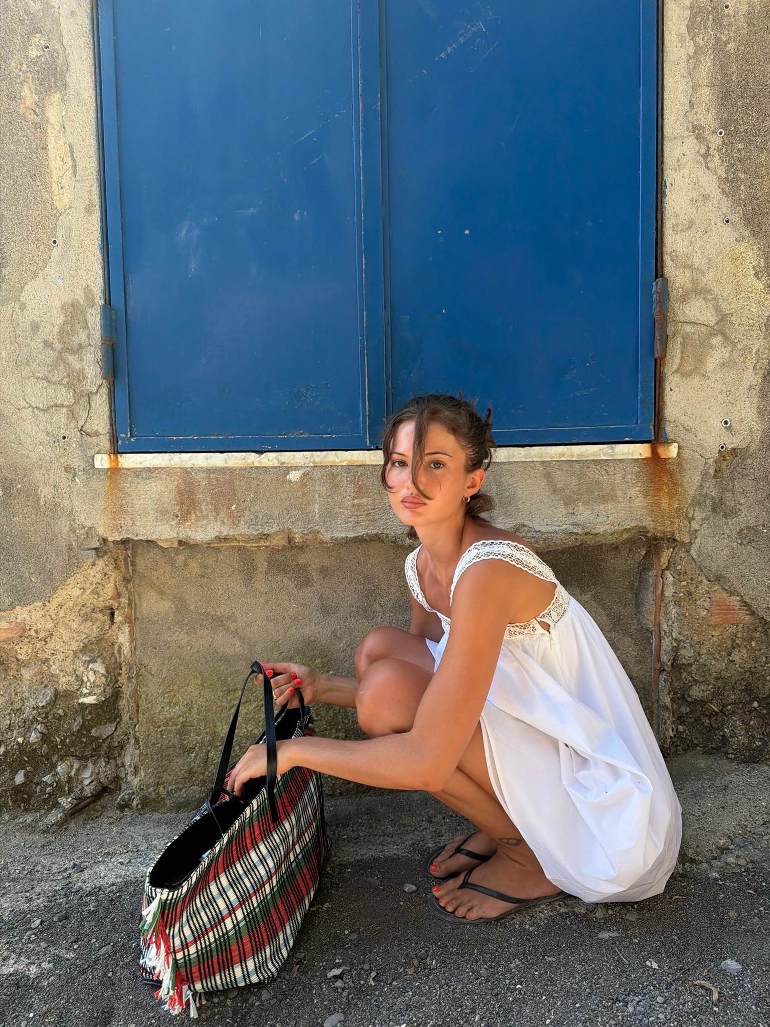 Woman wearing summer dress with flip-flops.
