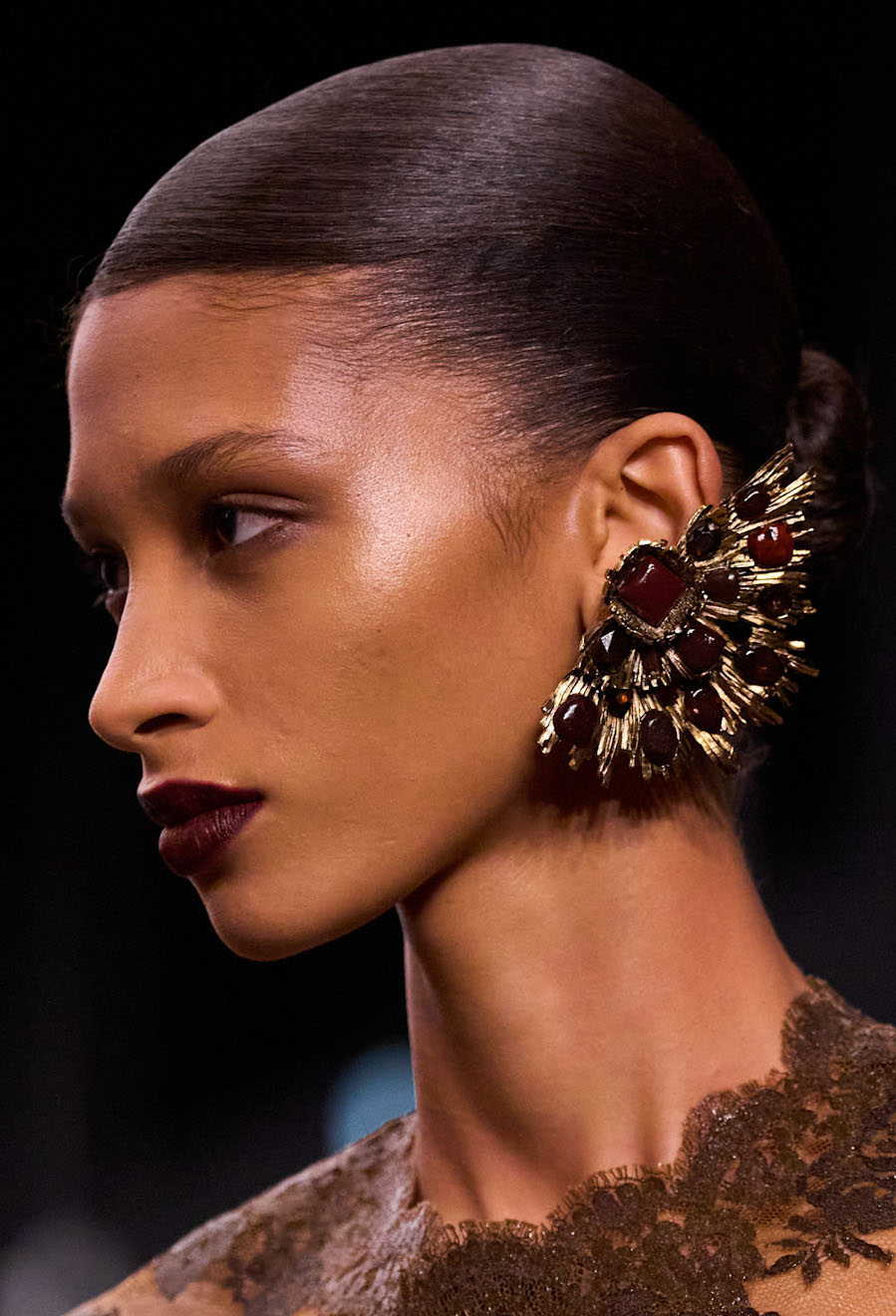 Woman with ornate earrings.