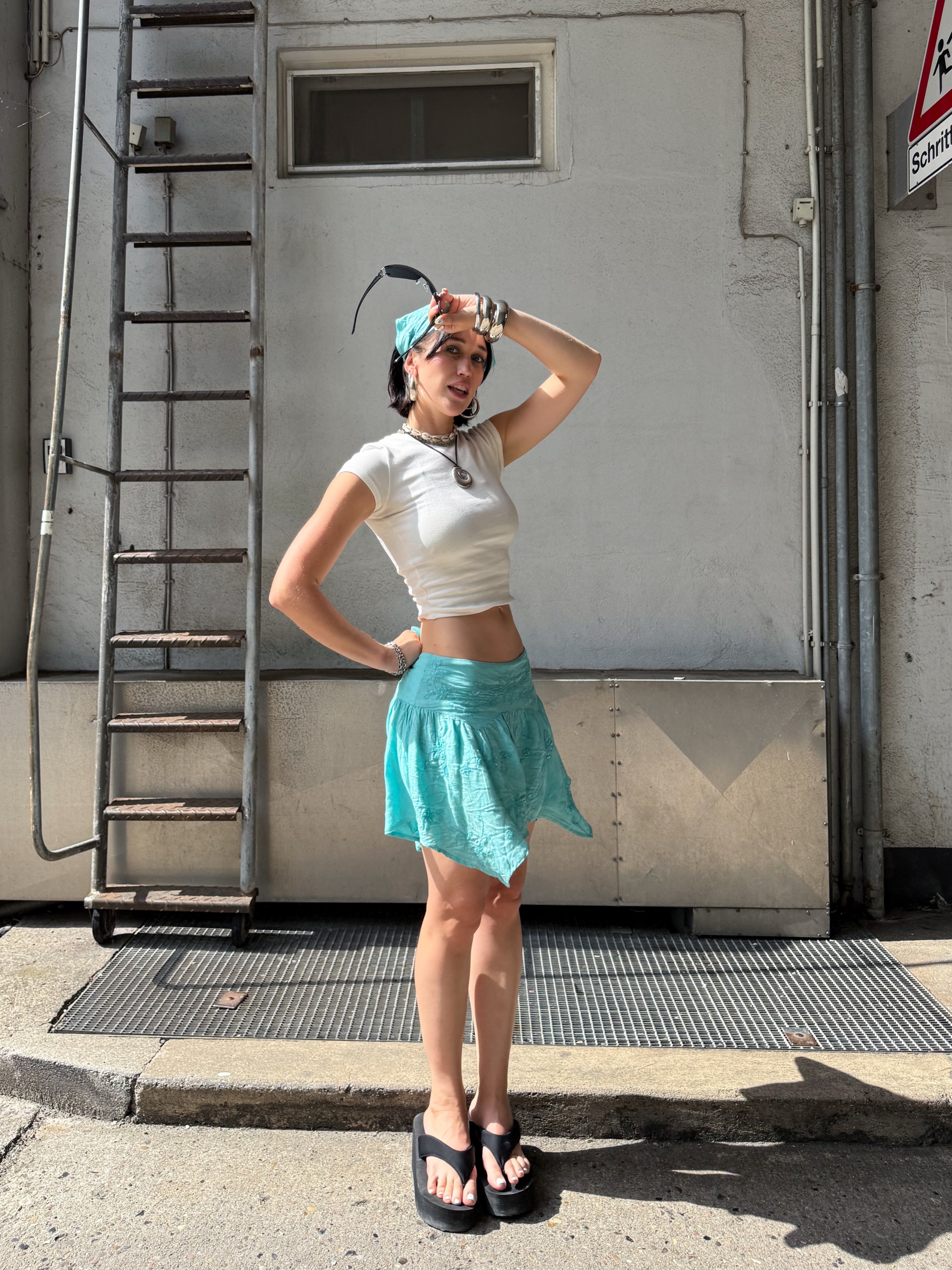 An image of a woman wearing asymmetric skirt outfit summer 2026
