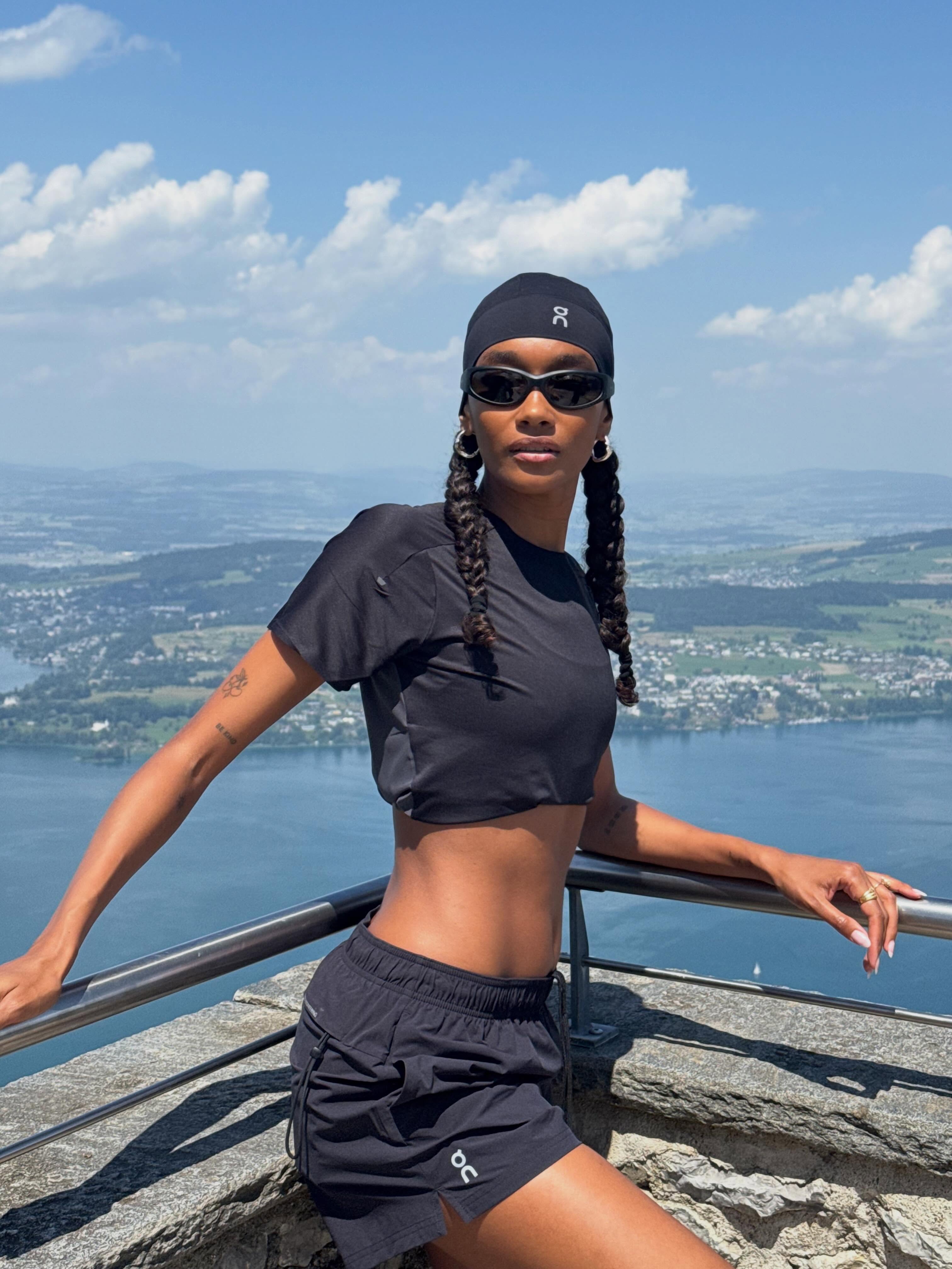 A woman wearing an all-black athletic outfit on a walk.