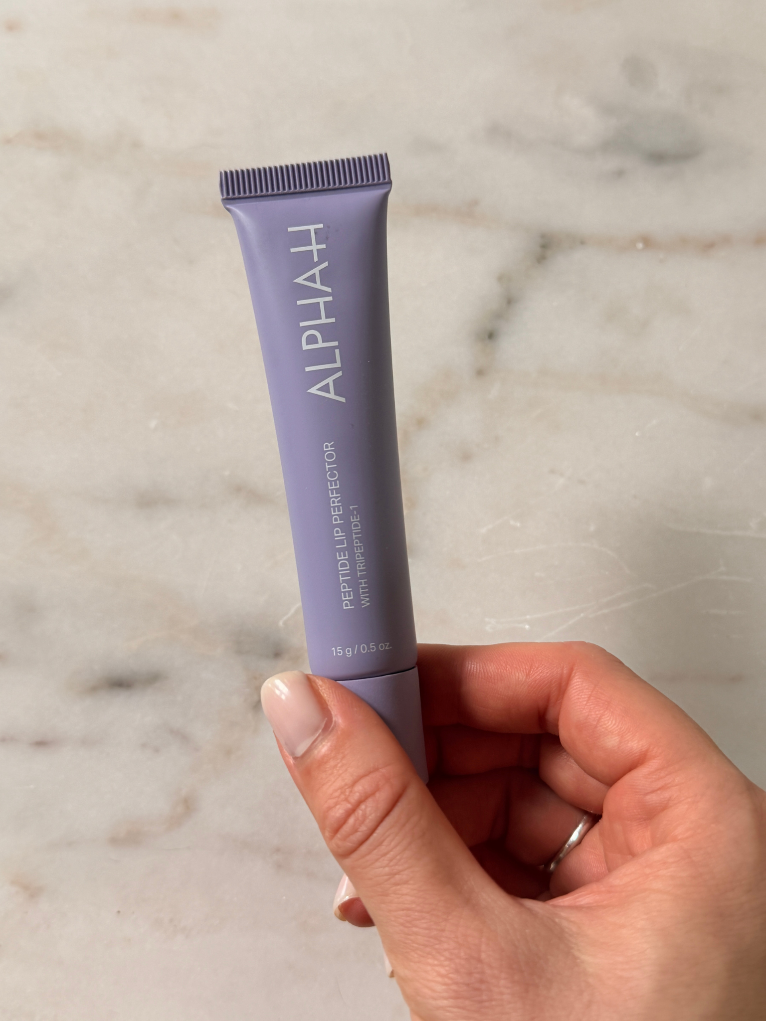 Grace holding the Alpha-H Lip Balm