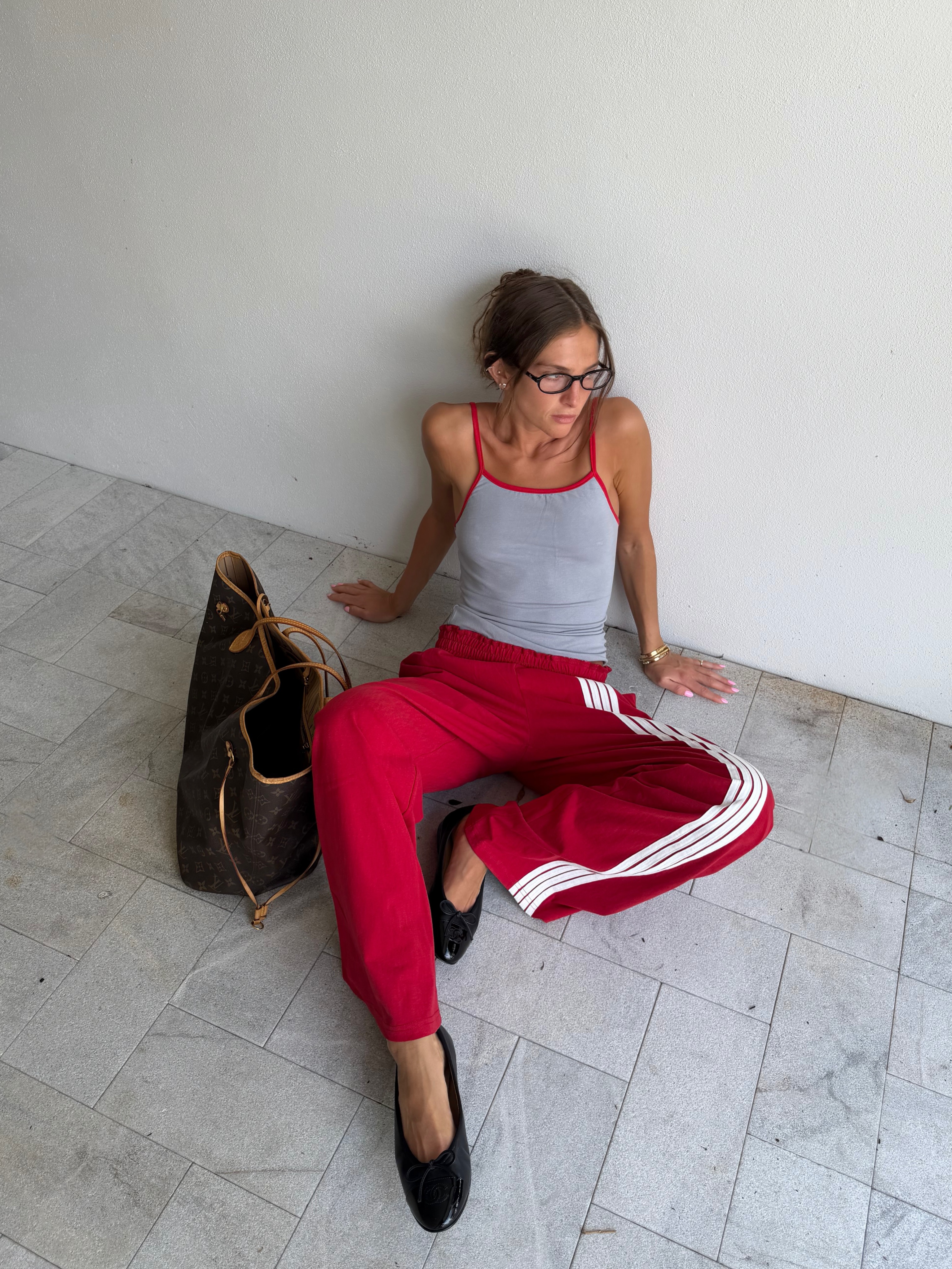Woman in track pants and tank top.