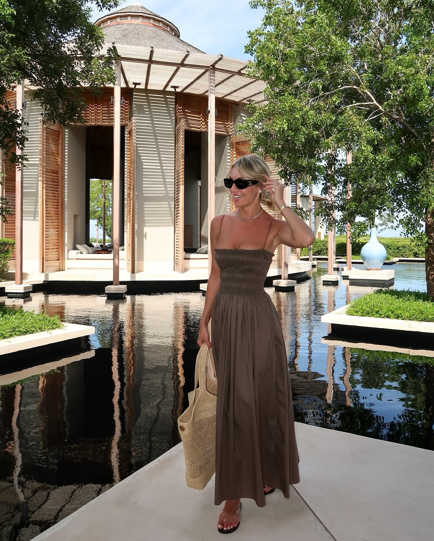 Woman wears Matteau shirred brown midi dress