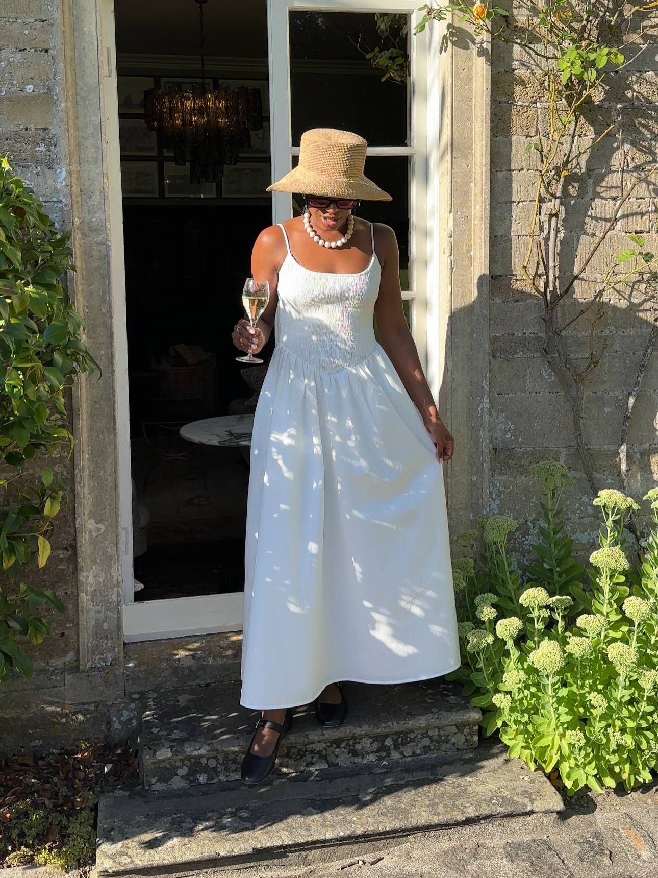 Taffy in white dress and raffia hat