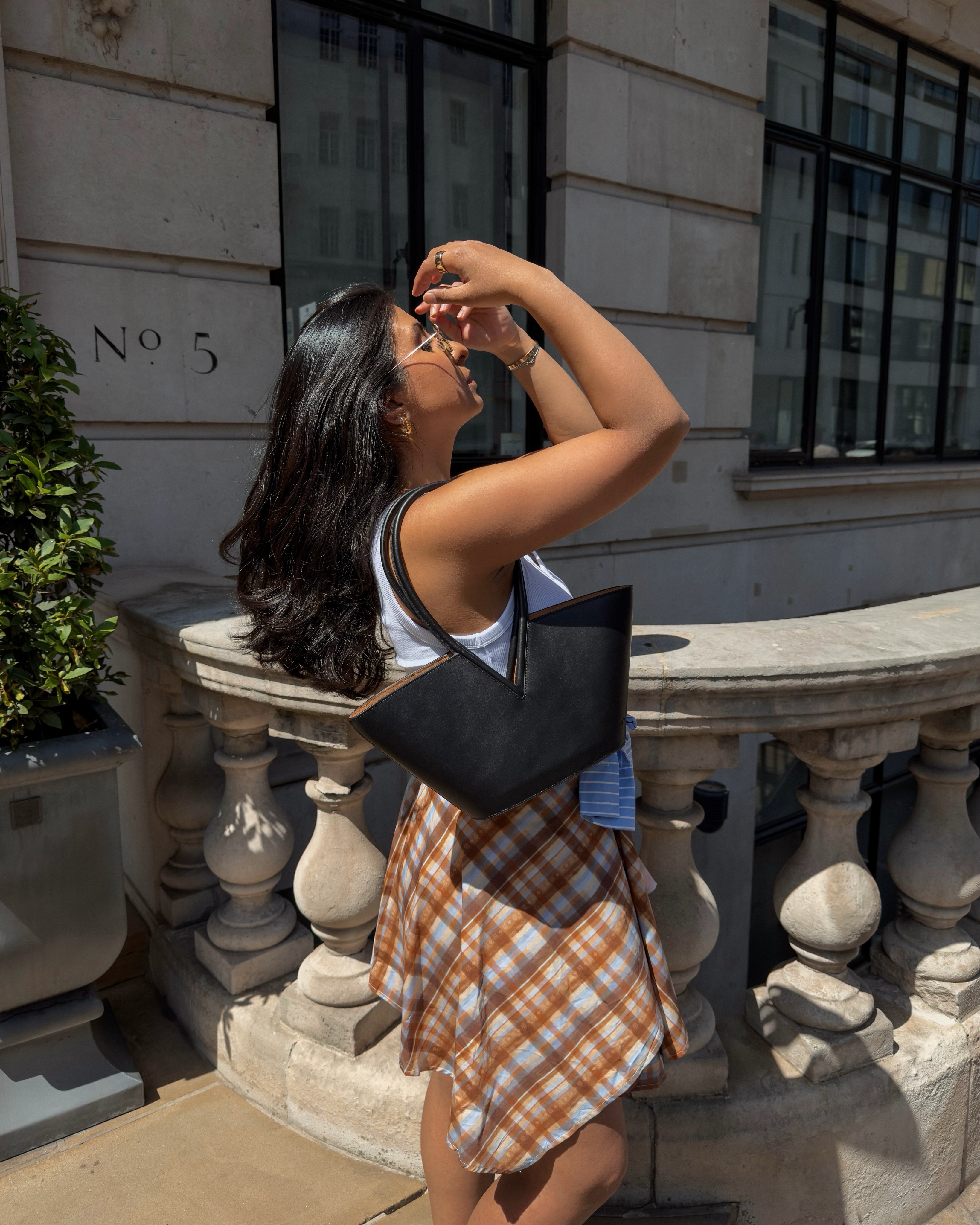 An image of a woman wearing asymmetric skirt outfit summer 2026