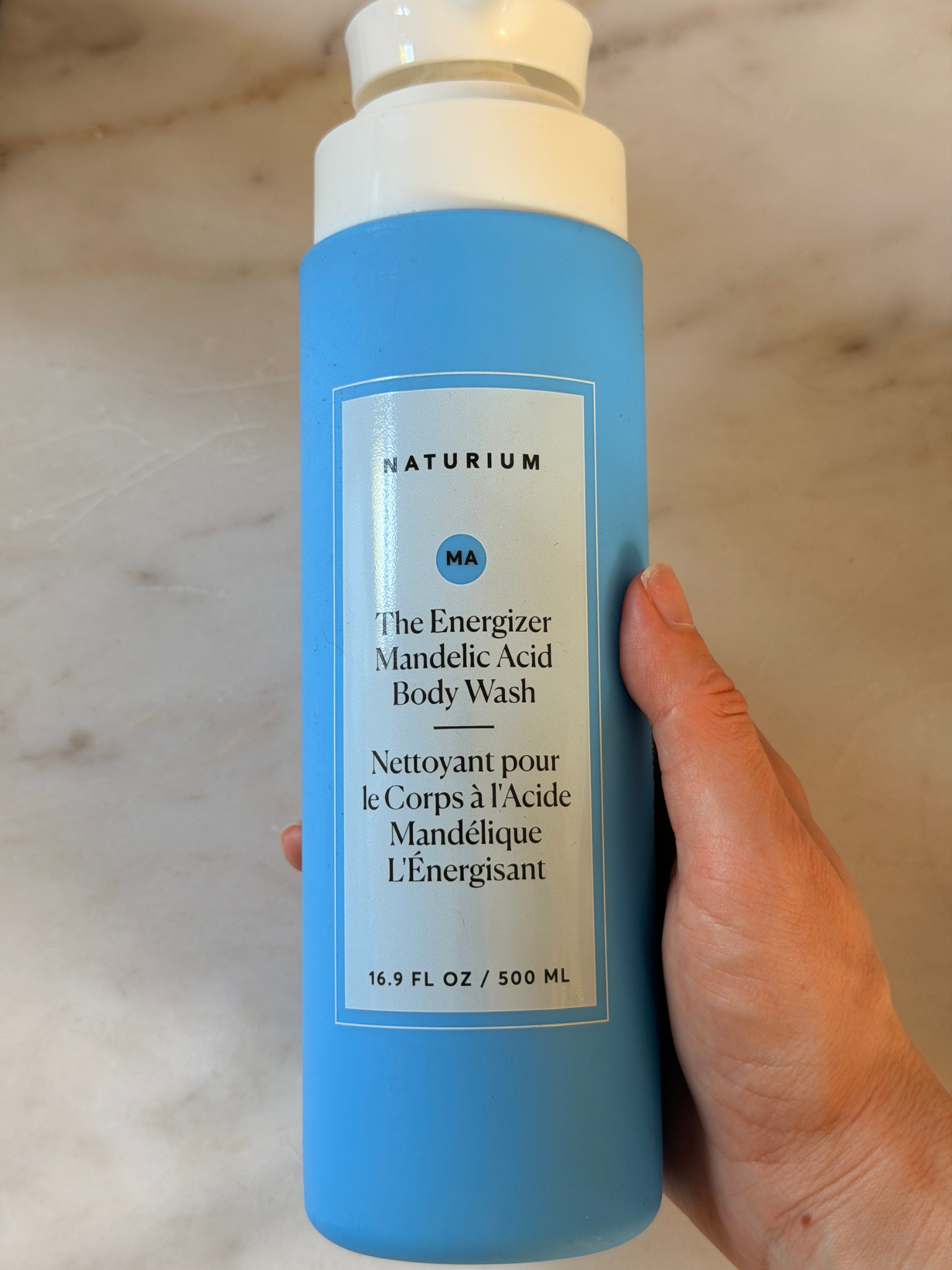 Grace Day holding the Naturium body wash