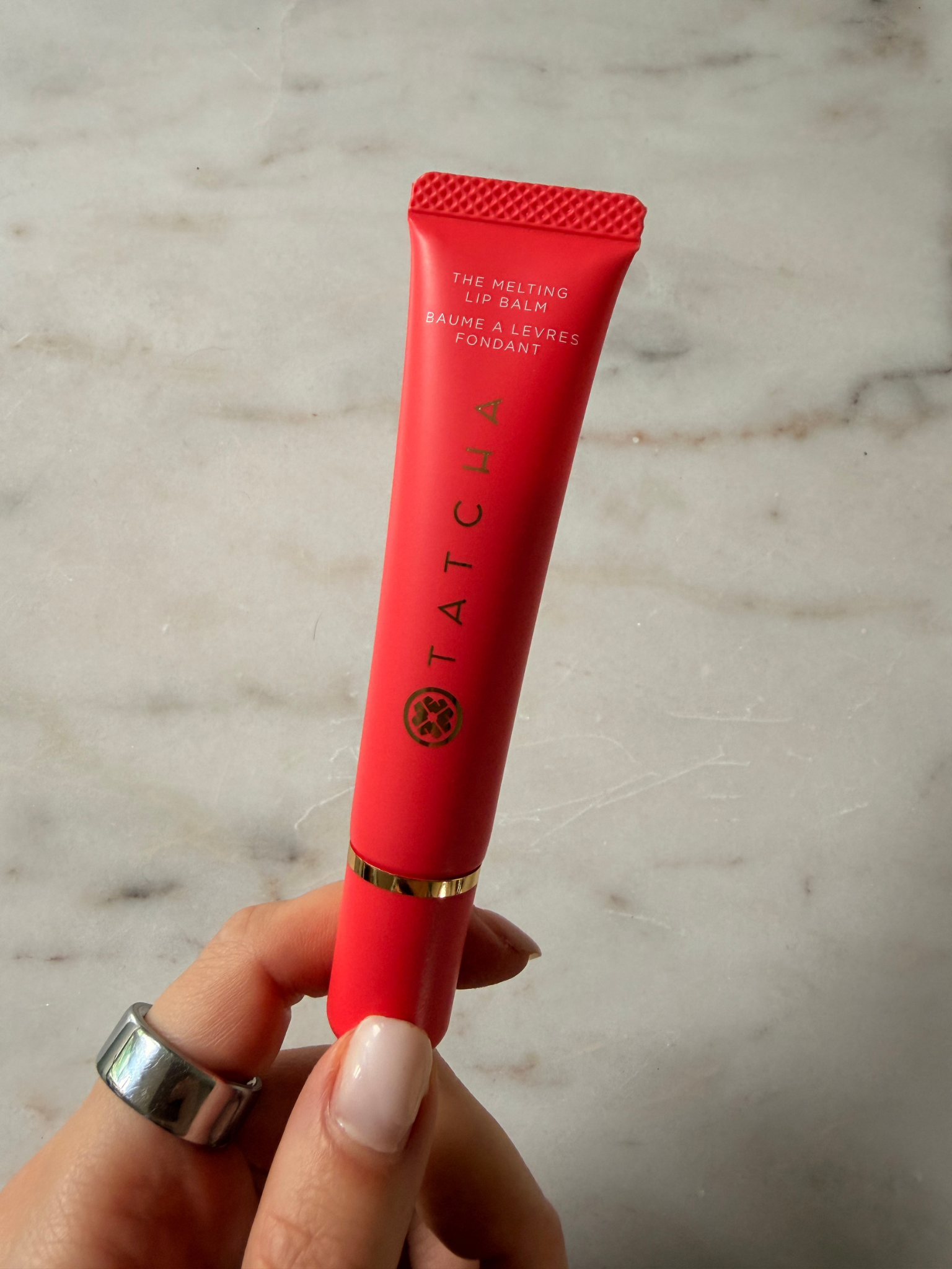 Grace holding the Tatcha Lip Balm